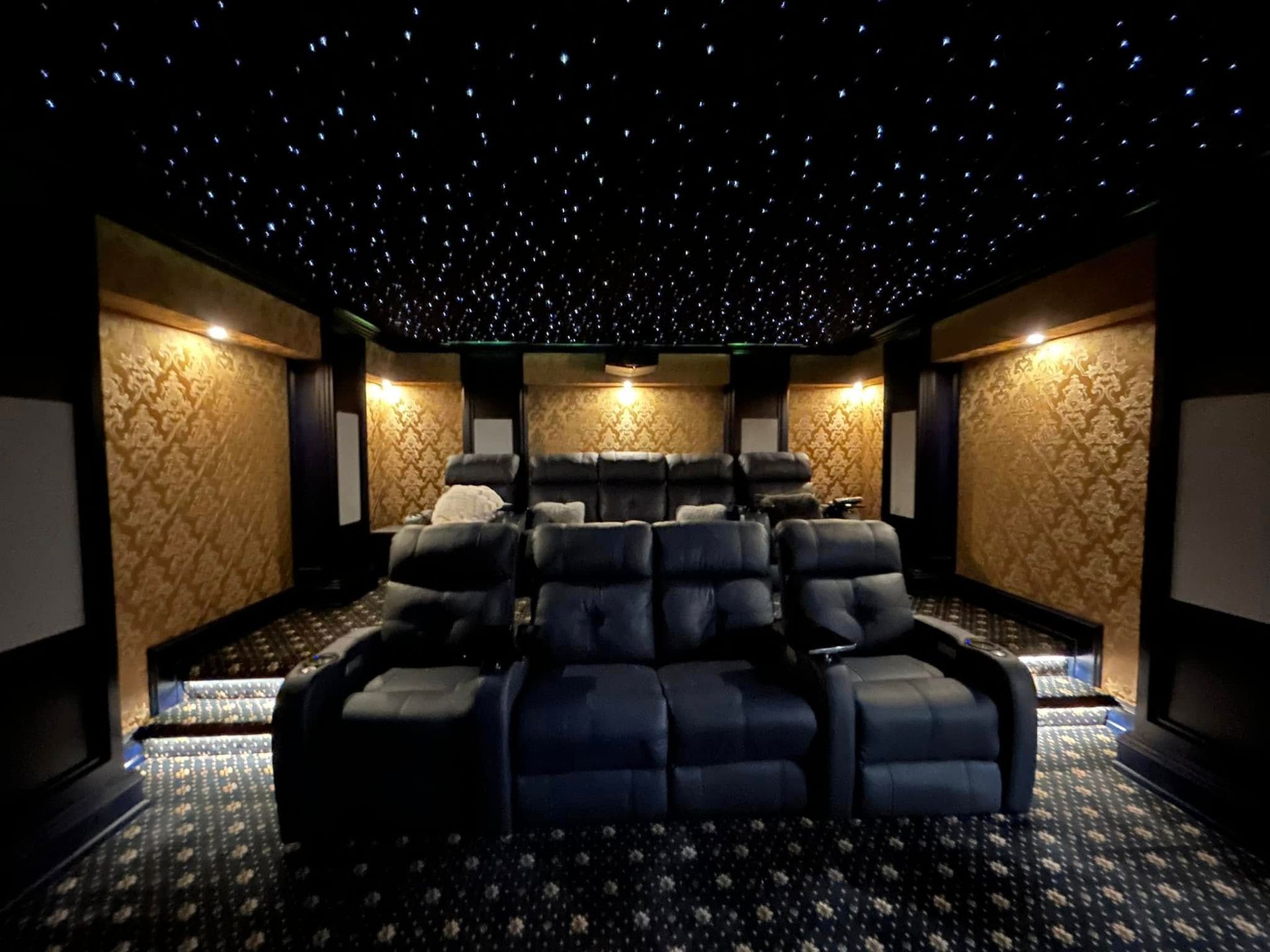 Custom home theater lighting installation with star ceiling and ambient wall lights