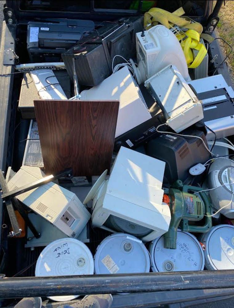 A pile of electronics in the back of a truck