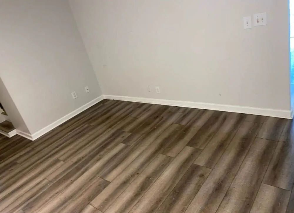 A room with a wooden floor and white trim.