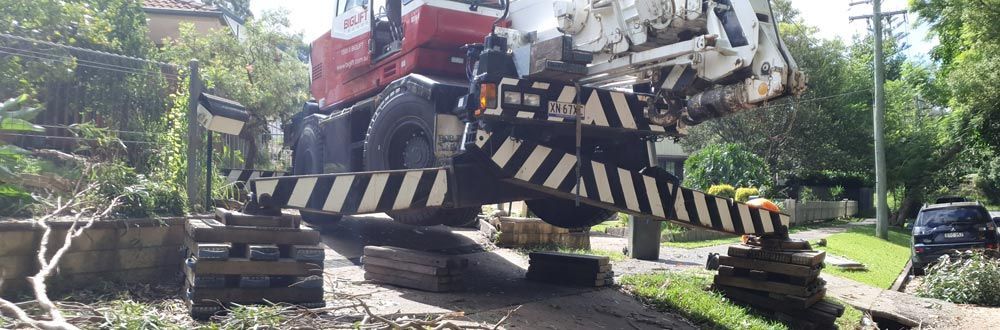 A large excavator is driving down a dirt road.