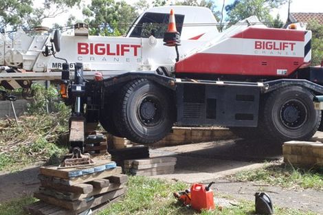 A biglift crane is parked on the side of the road