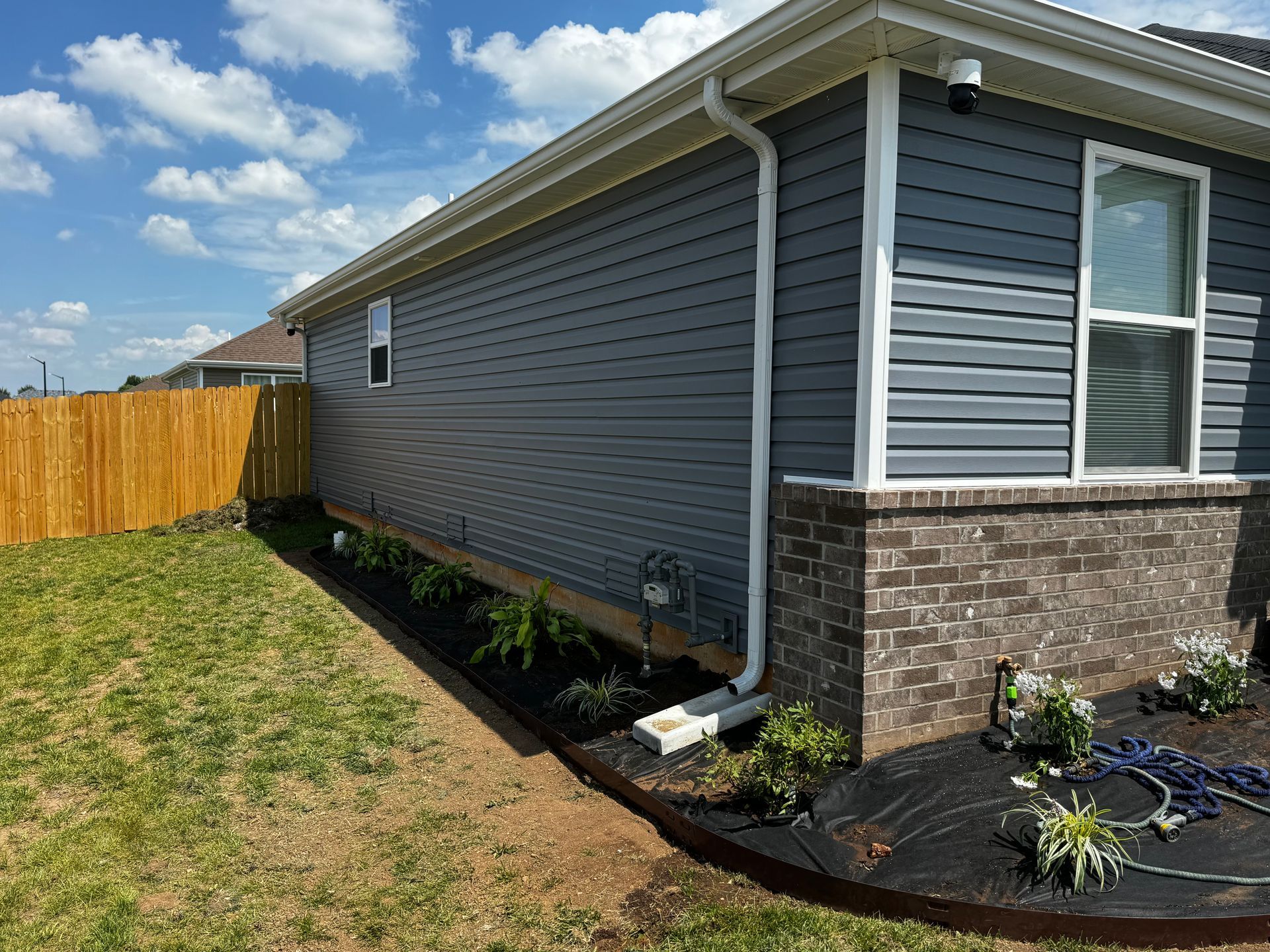 A house with a wooden fence in the backyard