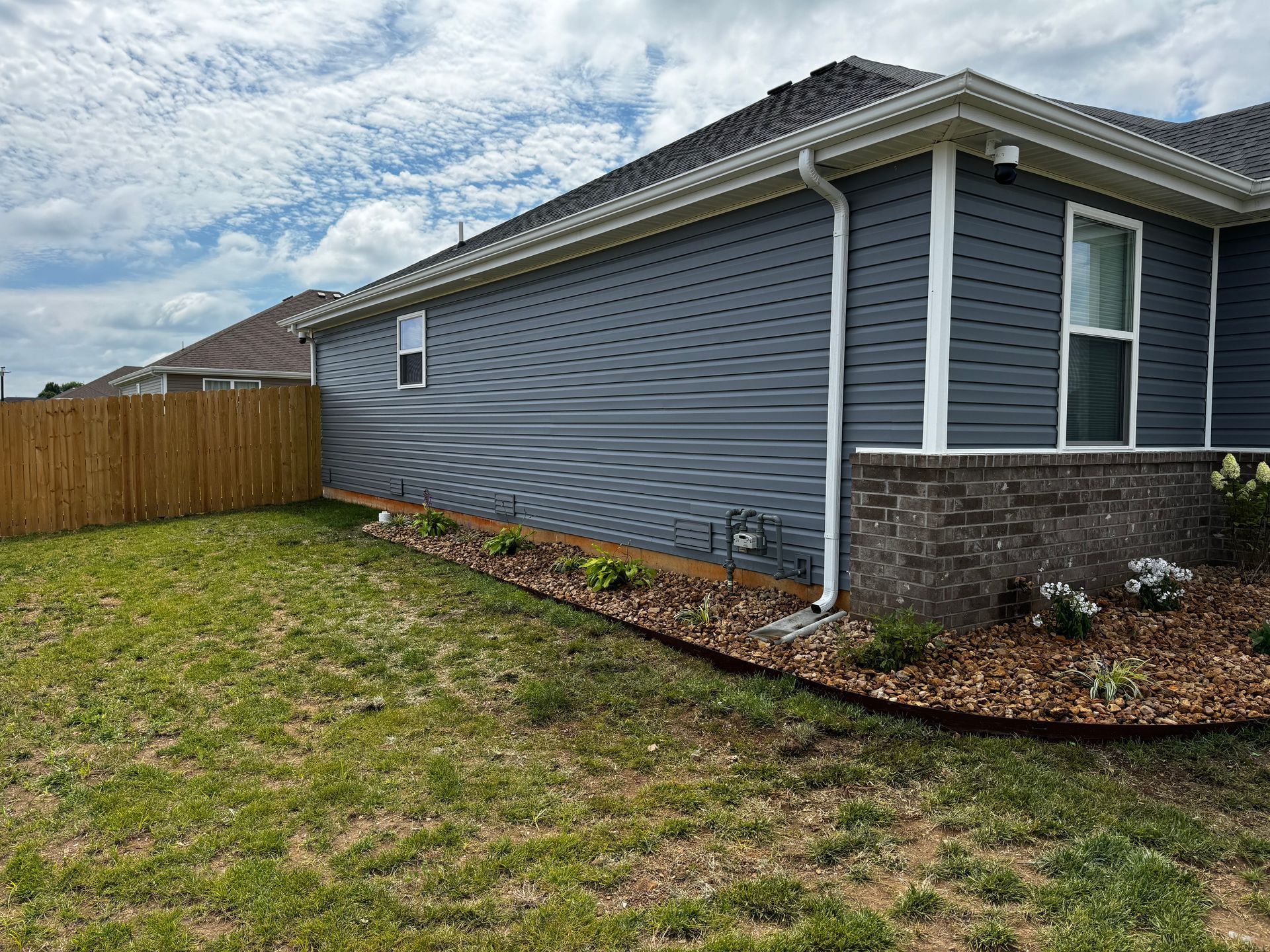 A house with a wooden fence in the backyard