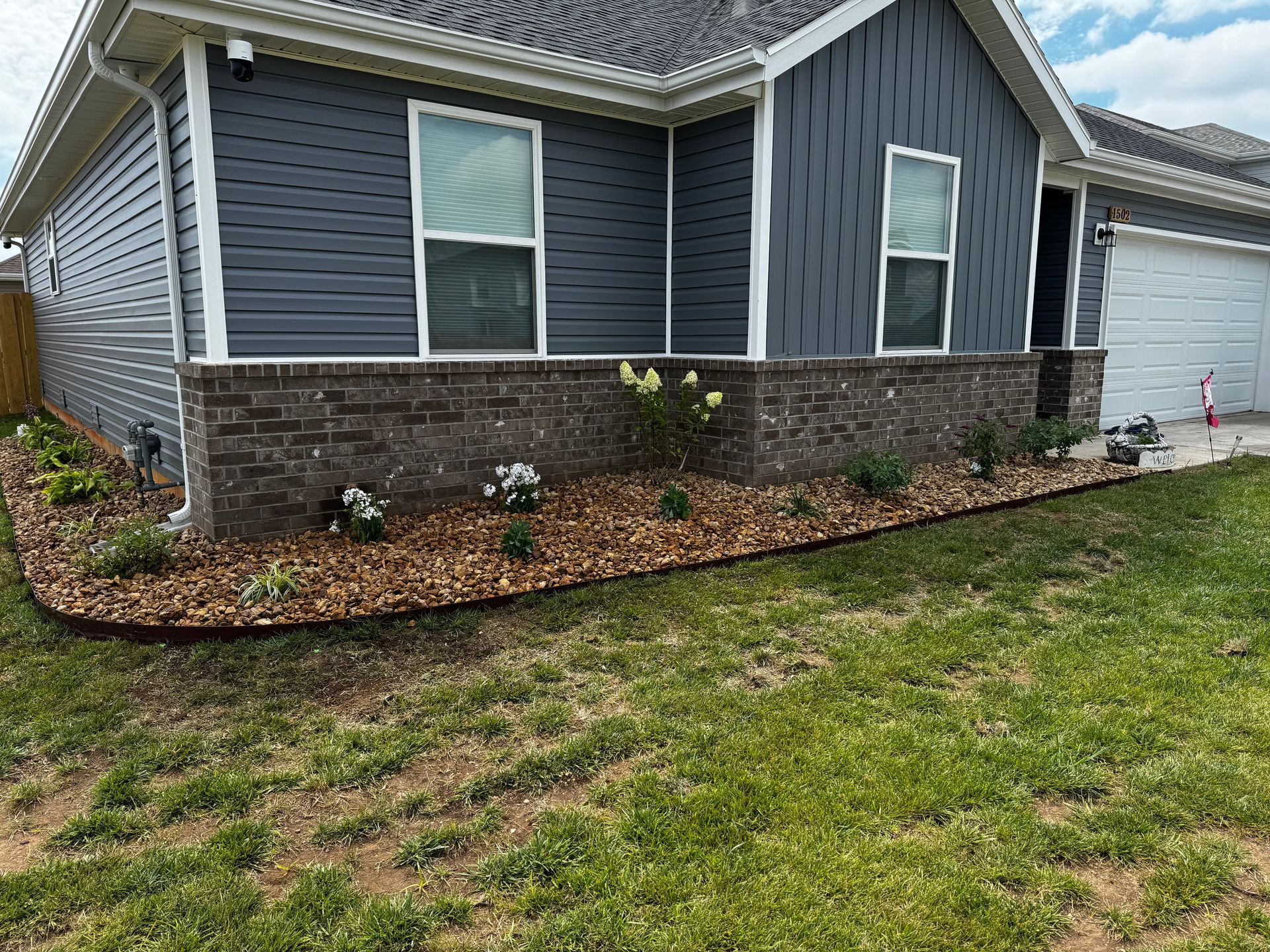 A house with a lot of plants in front of it