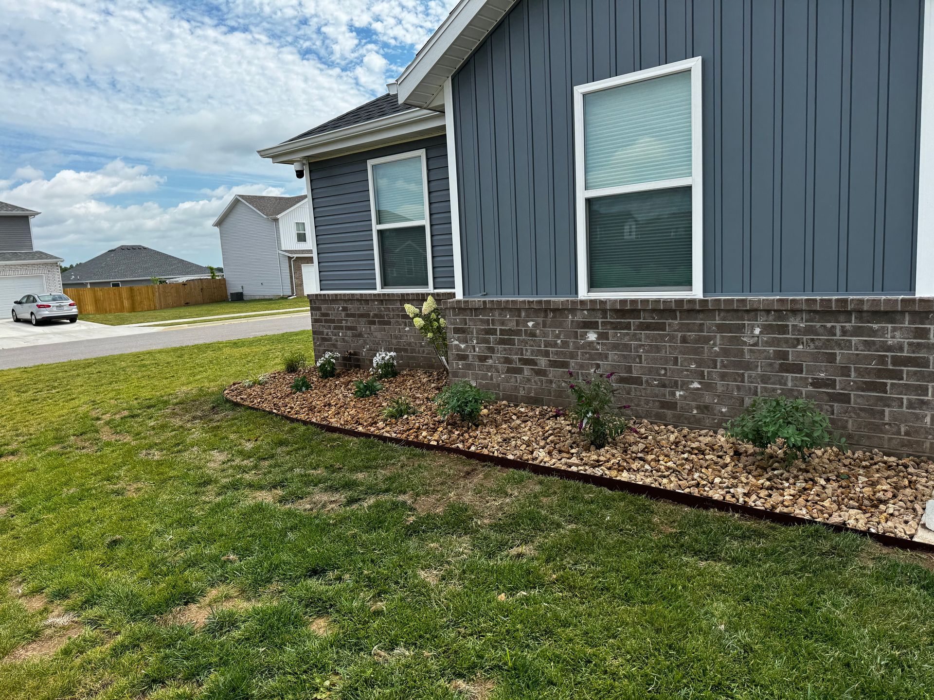 A house with a lot of windows and a brick wall