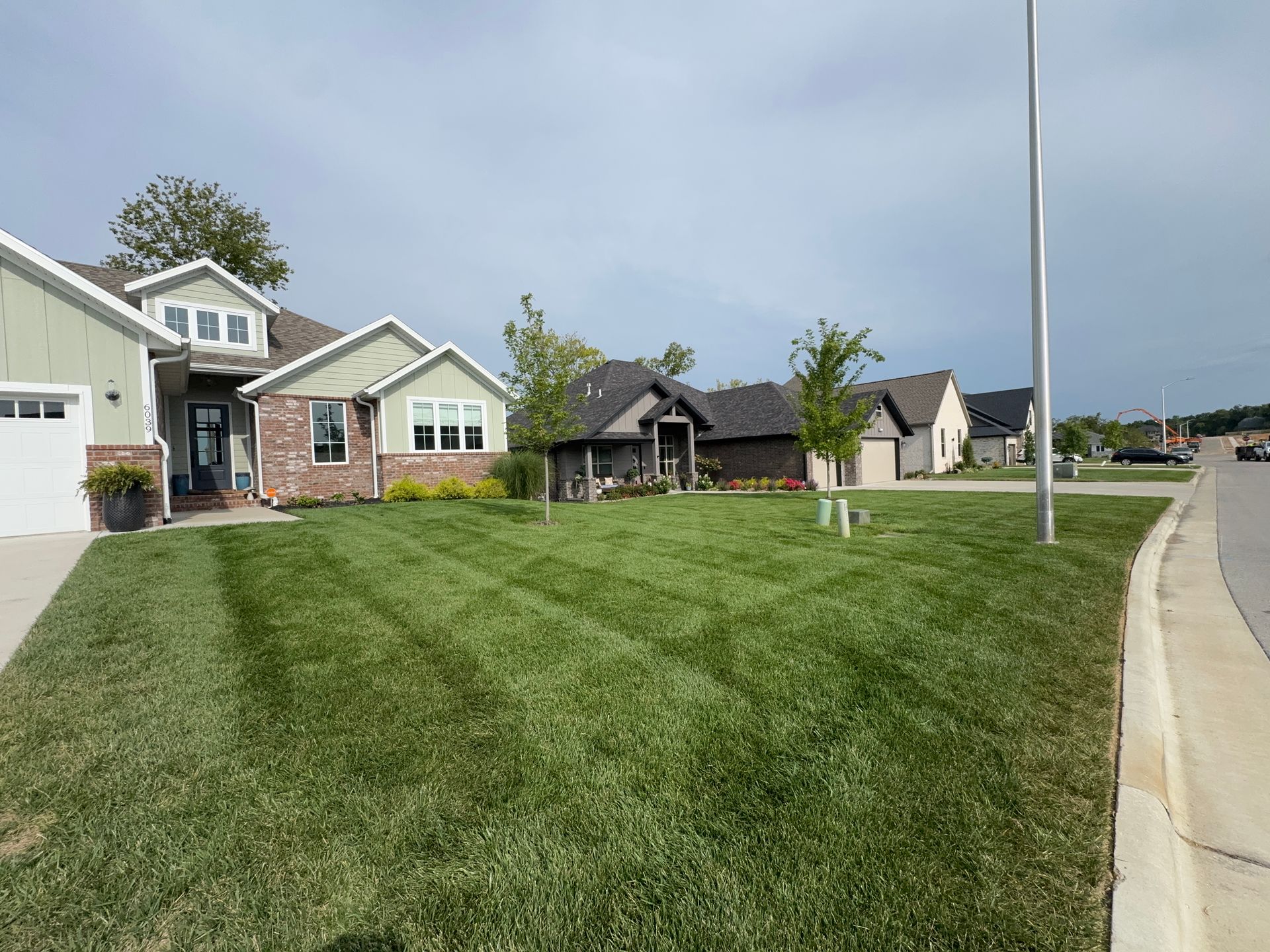 A house with a lush green lawn in front of it