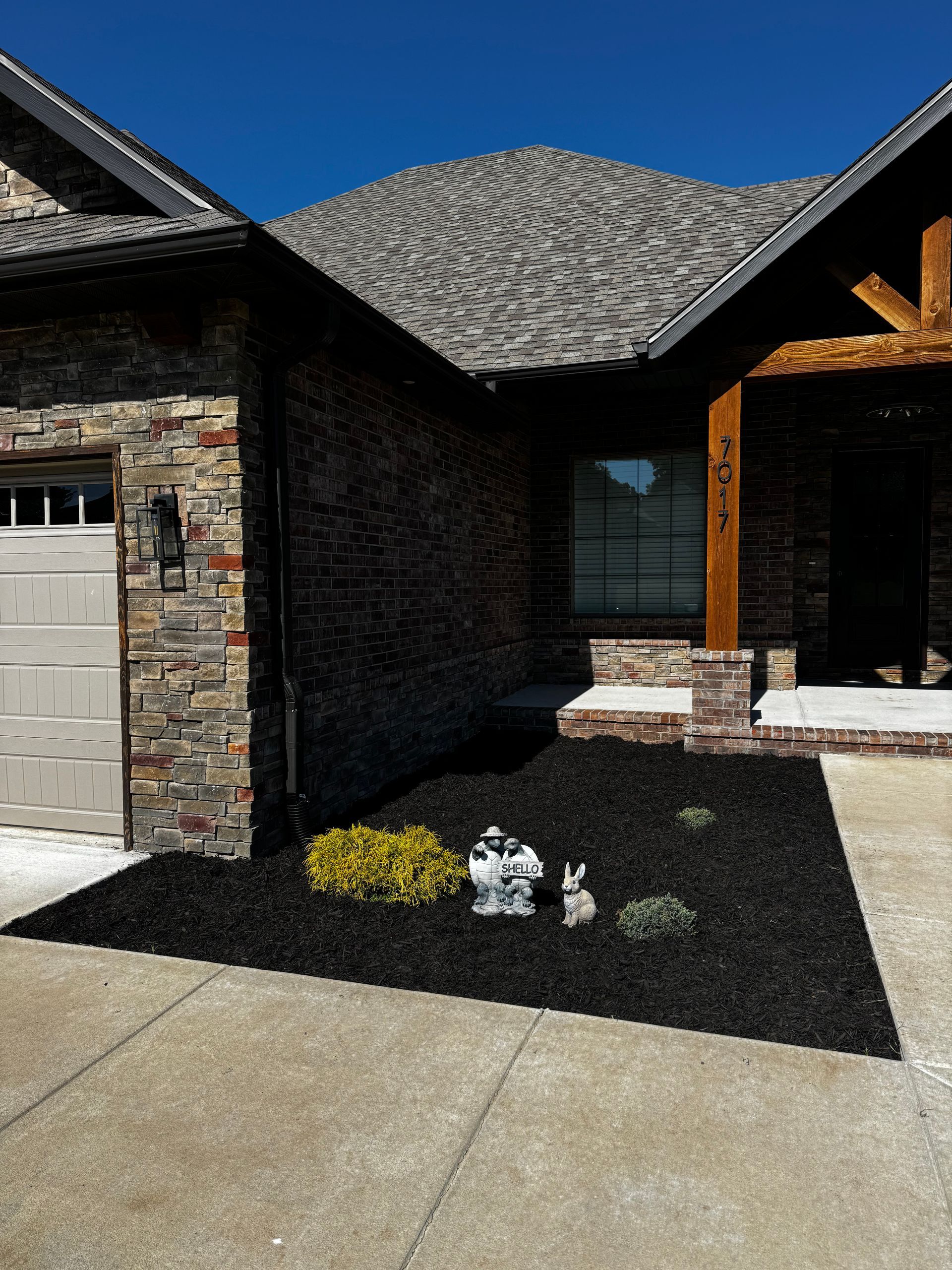 A brick house with a white garage door