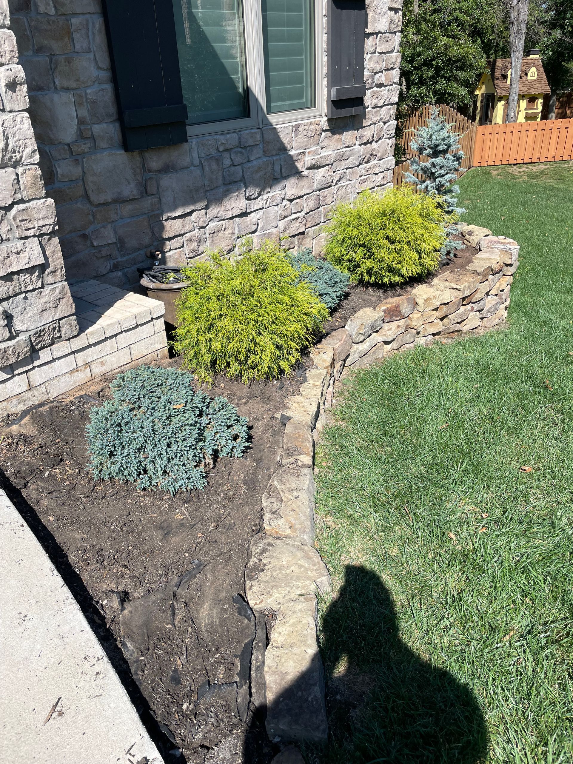 A brick house with a garden in front of it