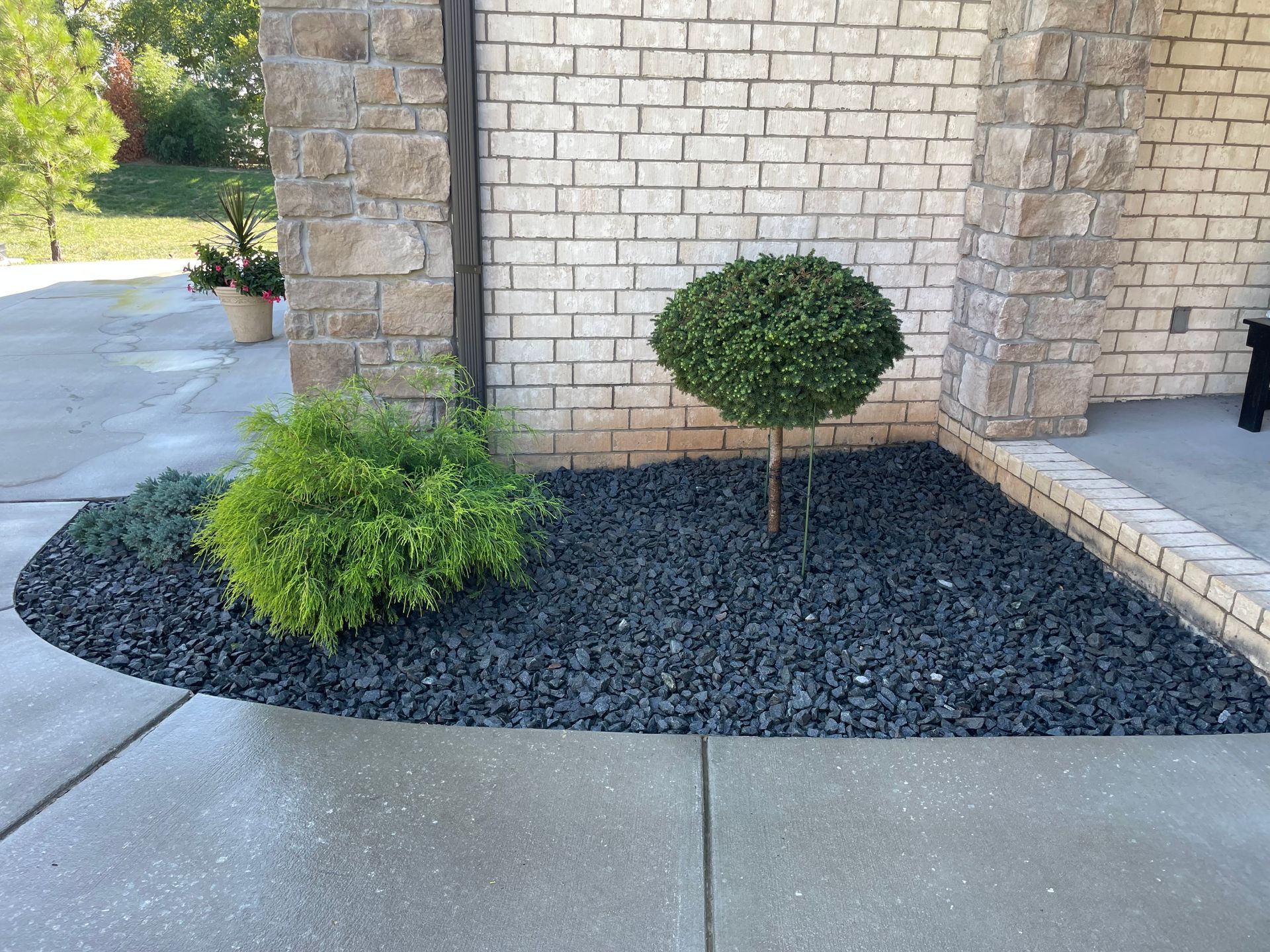 A brick building with a garden in front of it