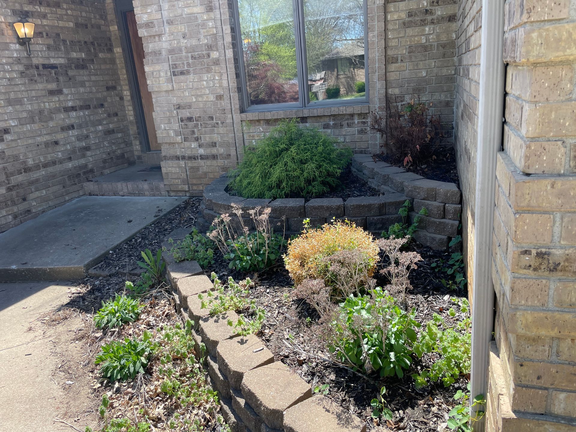 A brick house with a garden in front of it