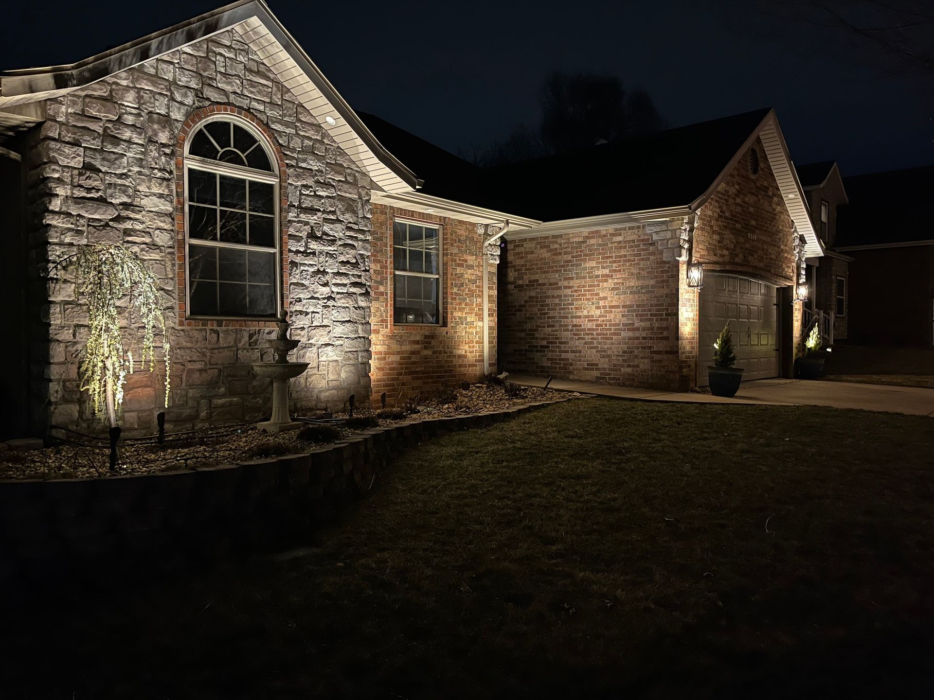 A brick house is lit up at night