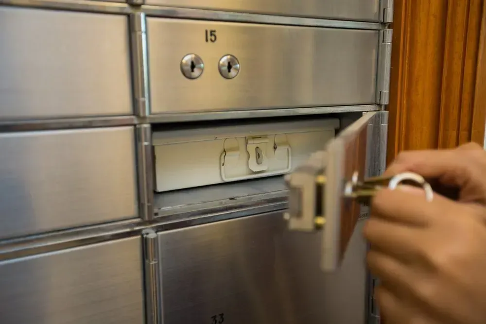 Person Using a Key to Open a Silver Safe Deposit Box in a Bank — North East Locksmiths in Wodonga, VIC