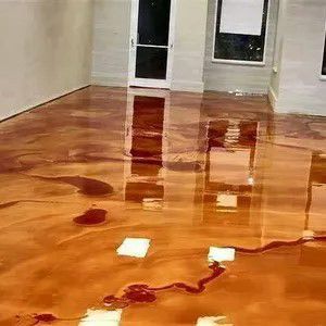 Flooded room with standing water reflecting windows and doors on a wooden floor