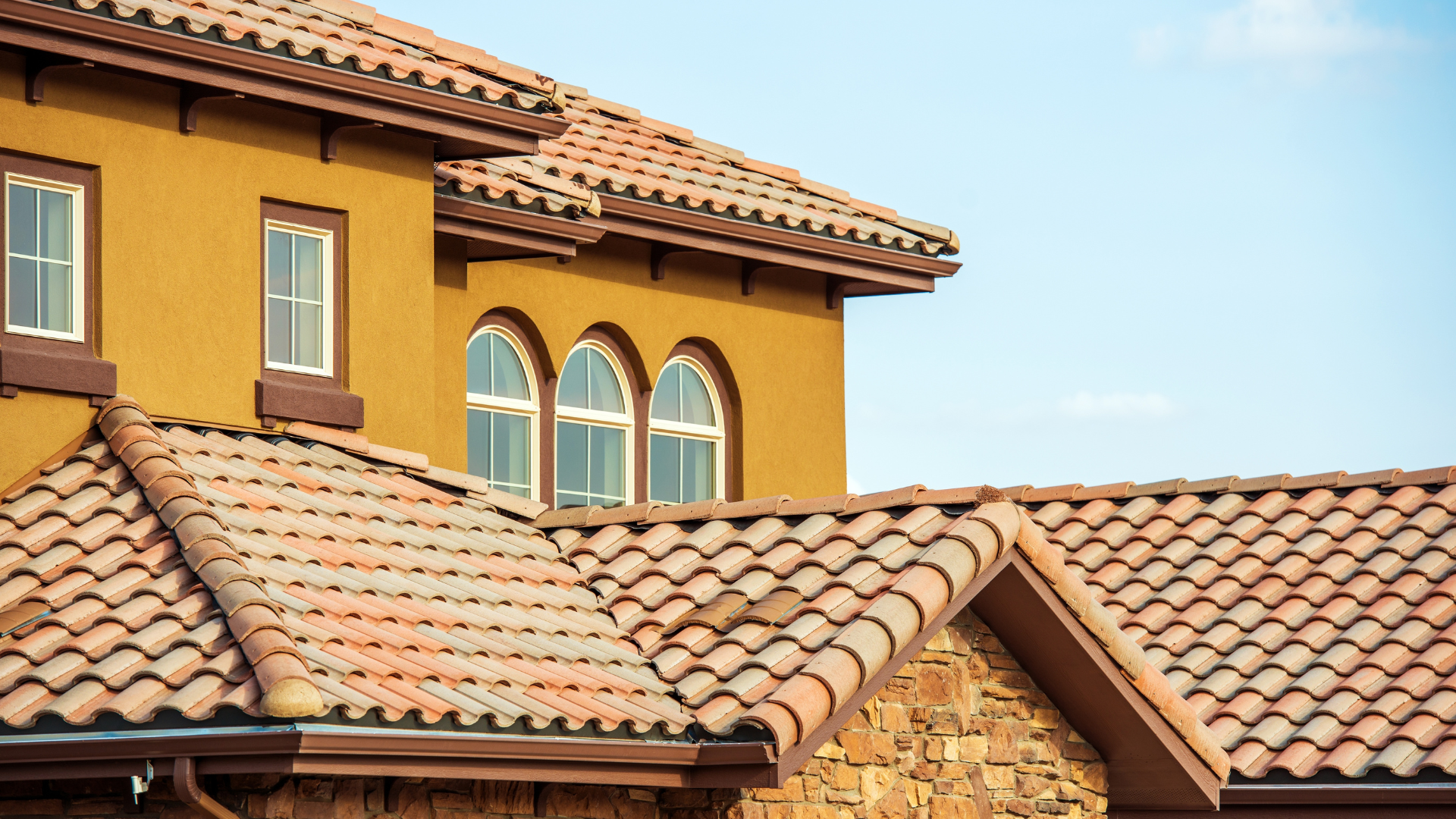 A house with a tiled roof and arched windows.