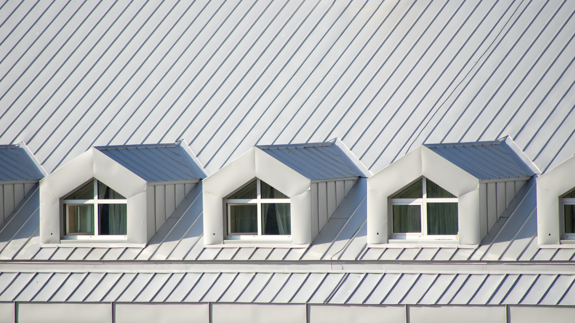 The roof of a building with a row of windows on it.