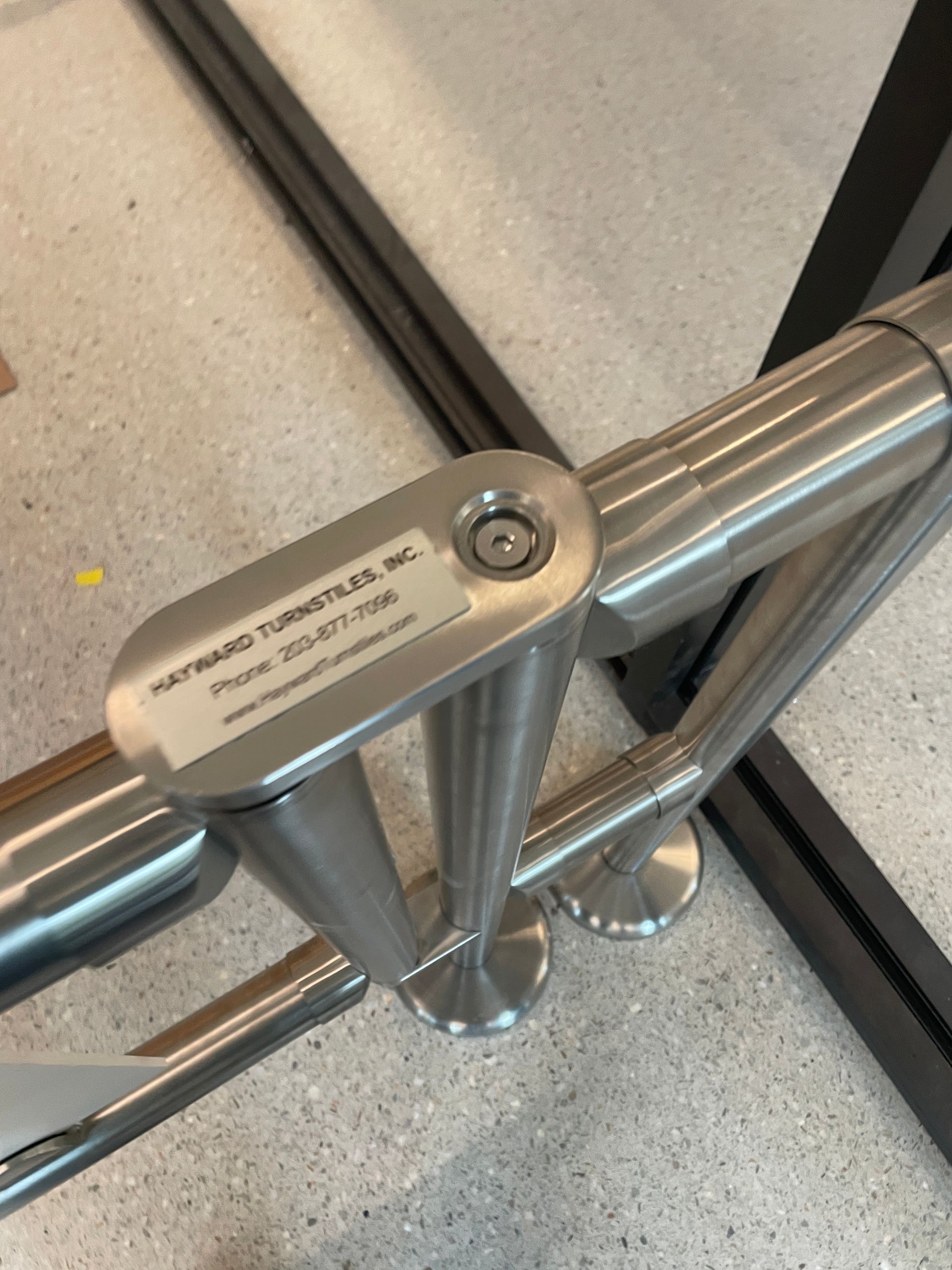 Stainless steel handrail section with manufacturer's plate, 