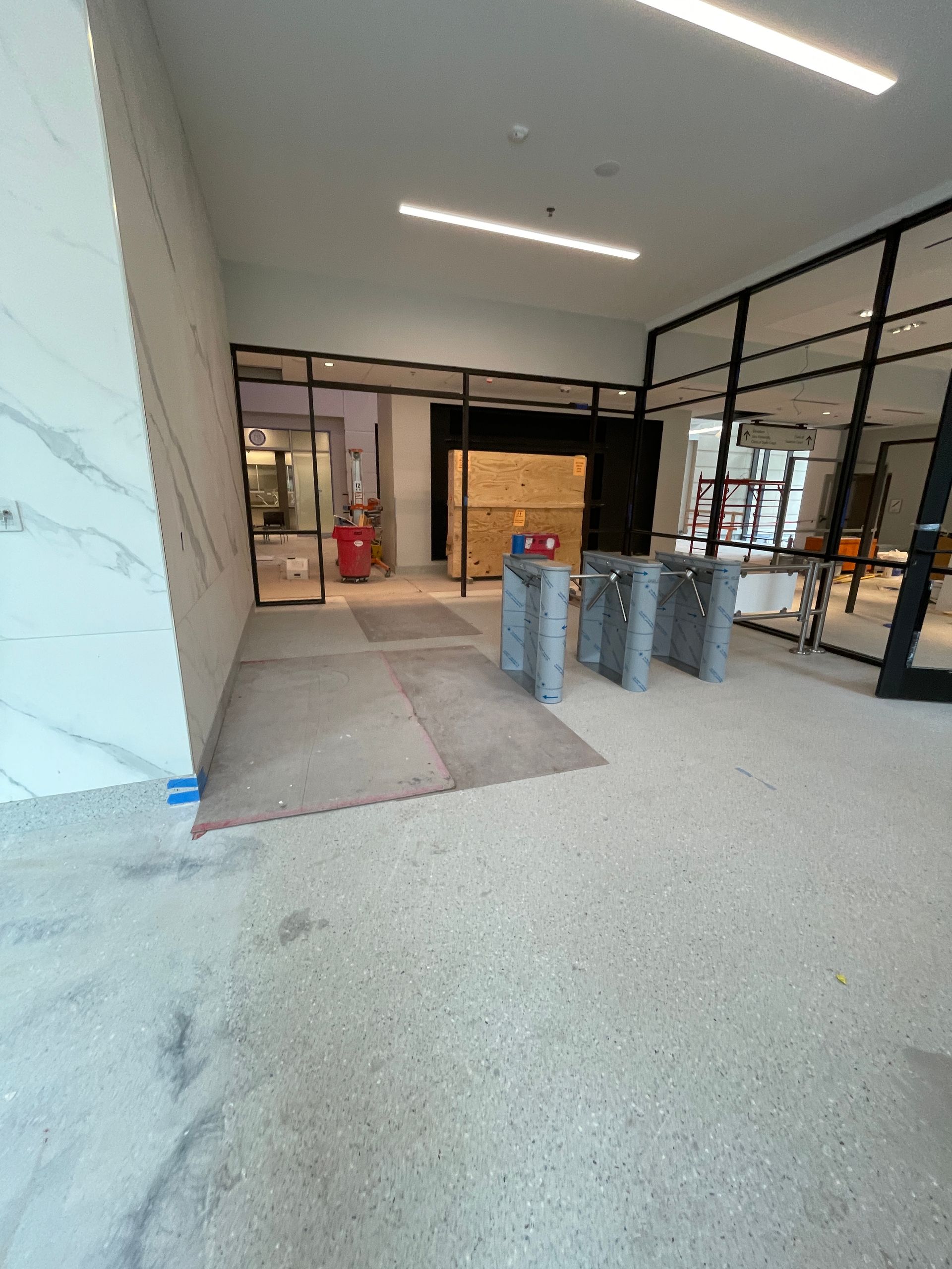 Lobby entrance with security gates and glass walls. 