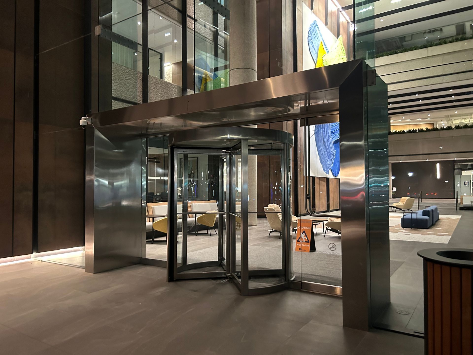Revolving door entrance to a modern building, stainless steel frame. 