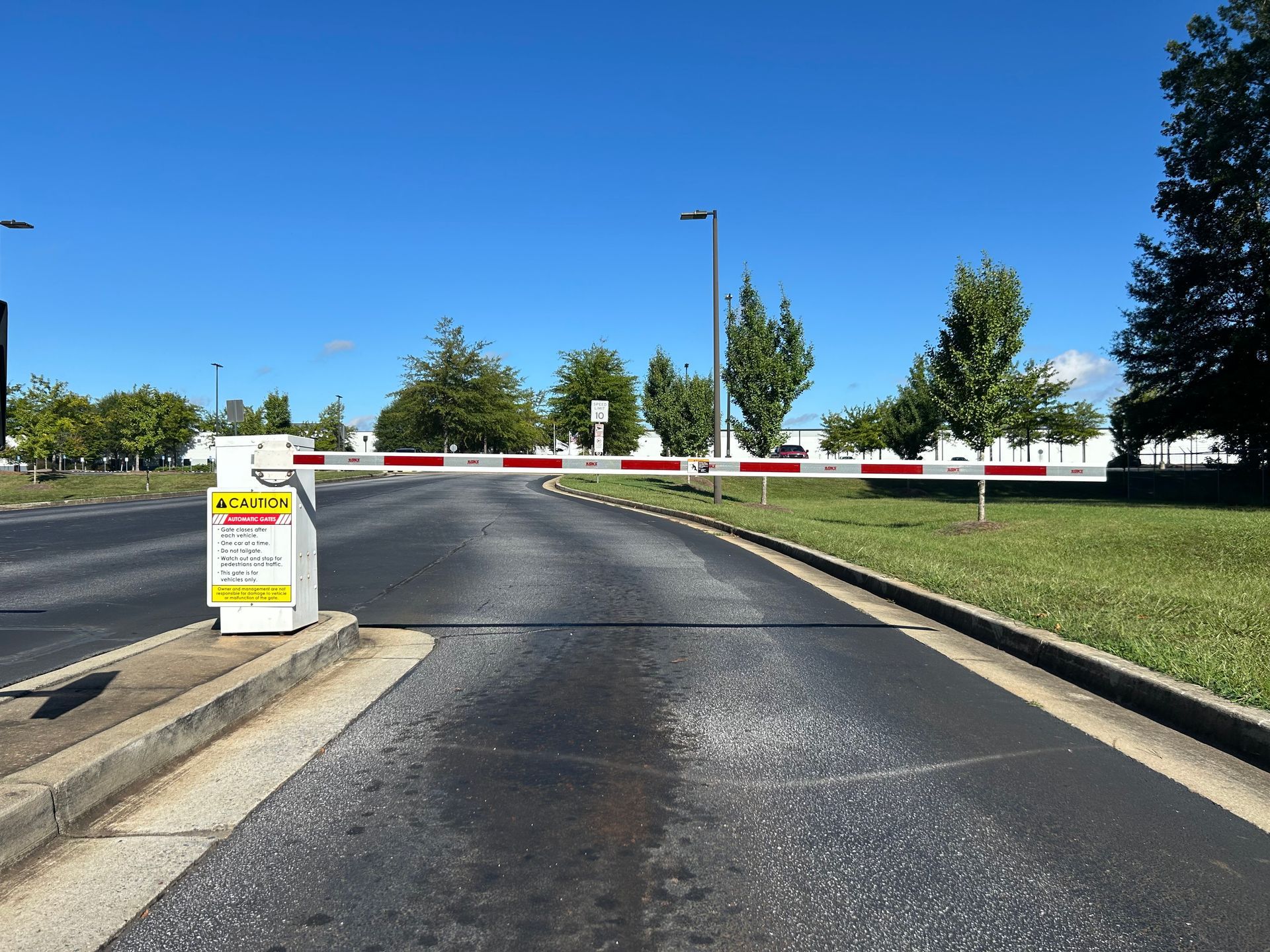 Entrance with a barrier gate in red and white stripes. 