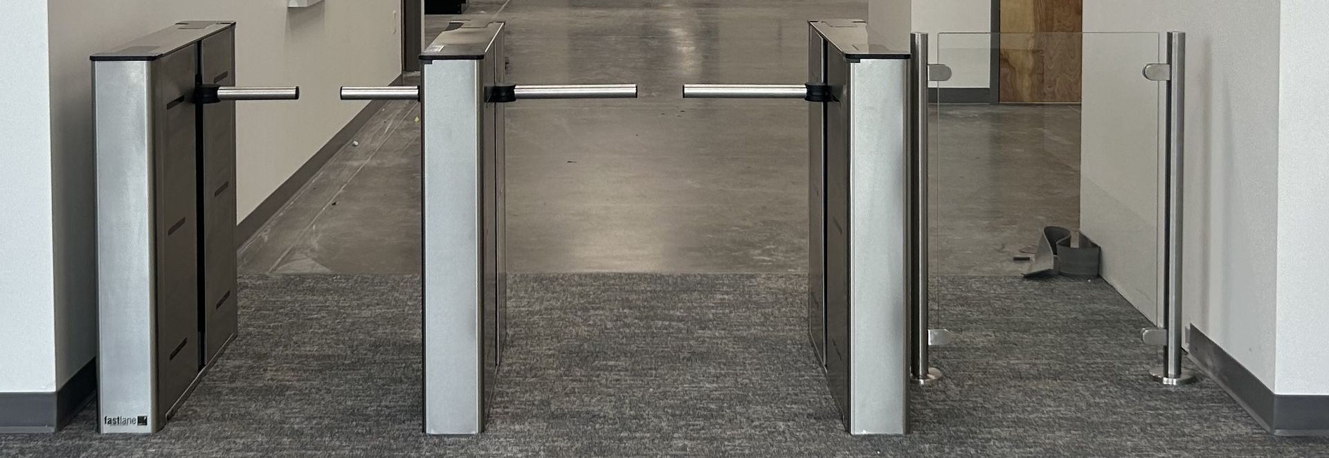 Turnstiles in a hallway, offering a passage. 