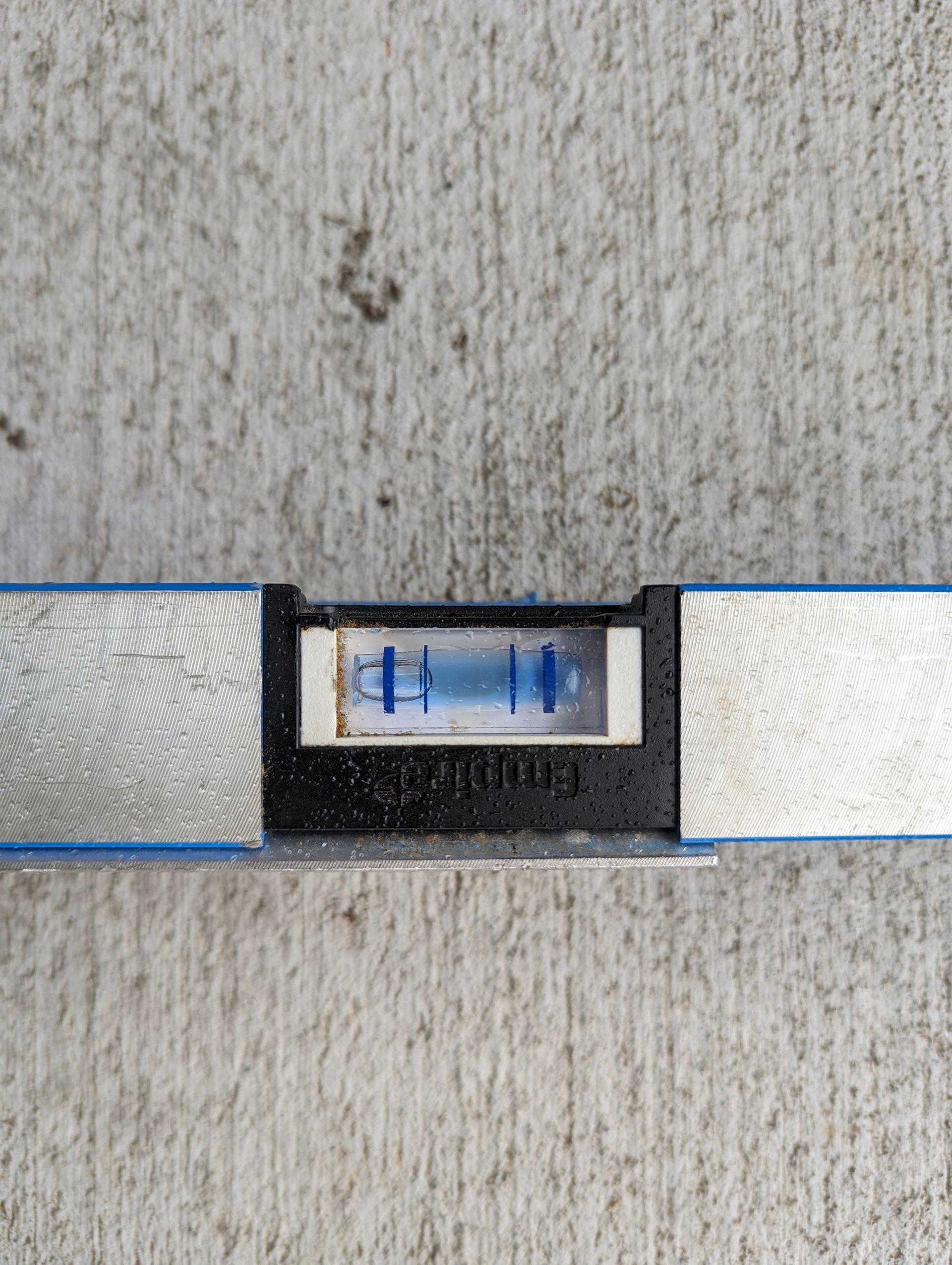 A level tool showing the bubble centered, indicating a surface is level.