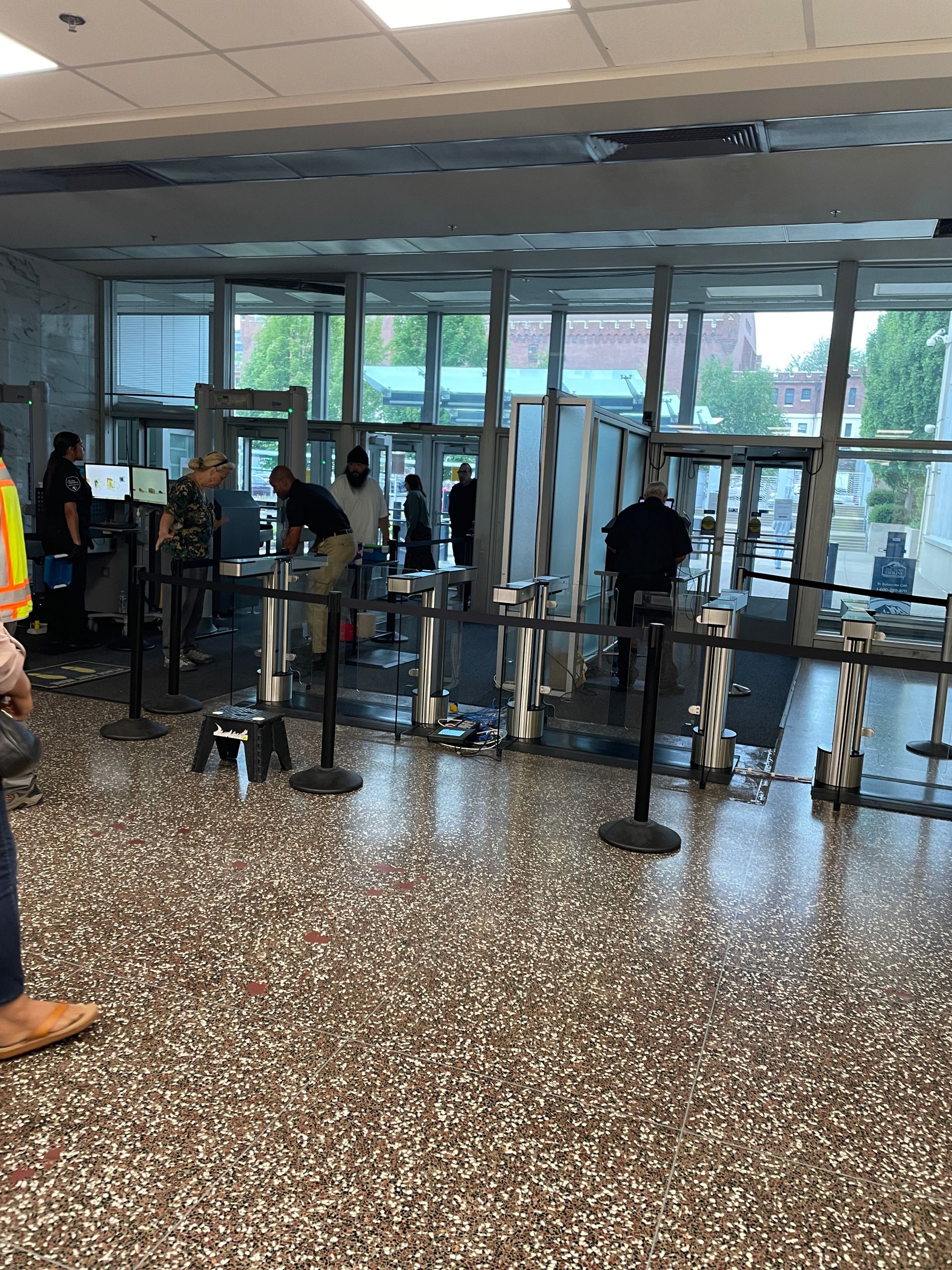 People waiting in line at an airport security checkpoint.