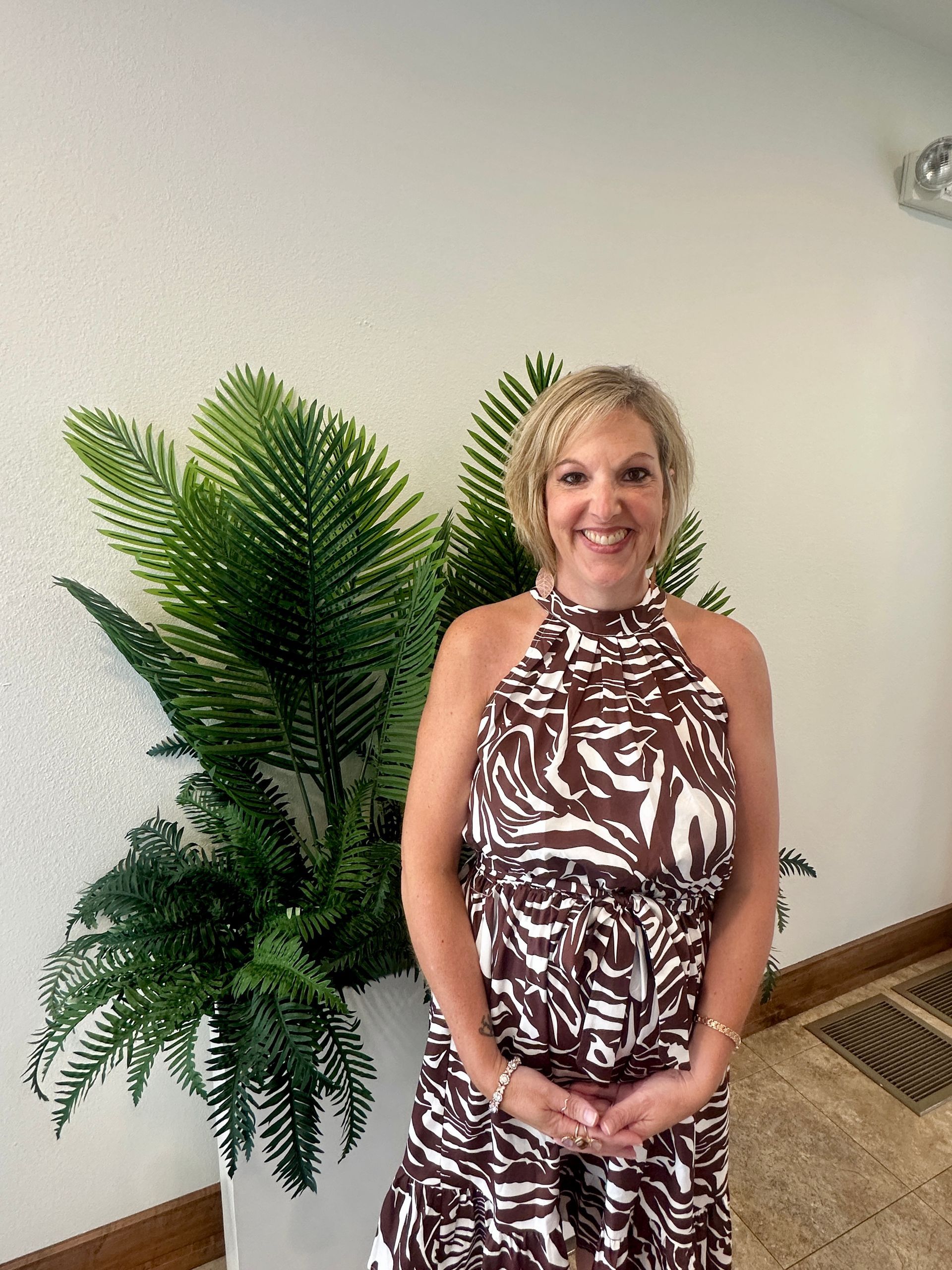 A silhouette of a person without a face on a gray background.