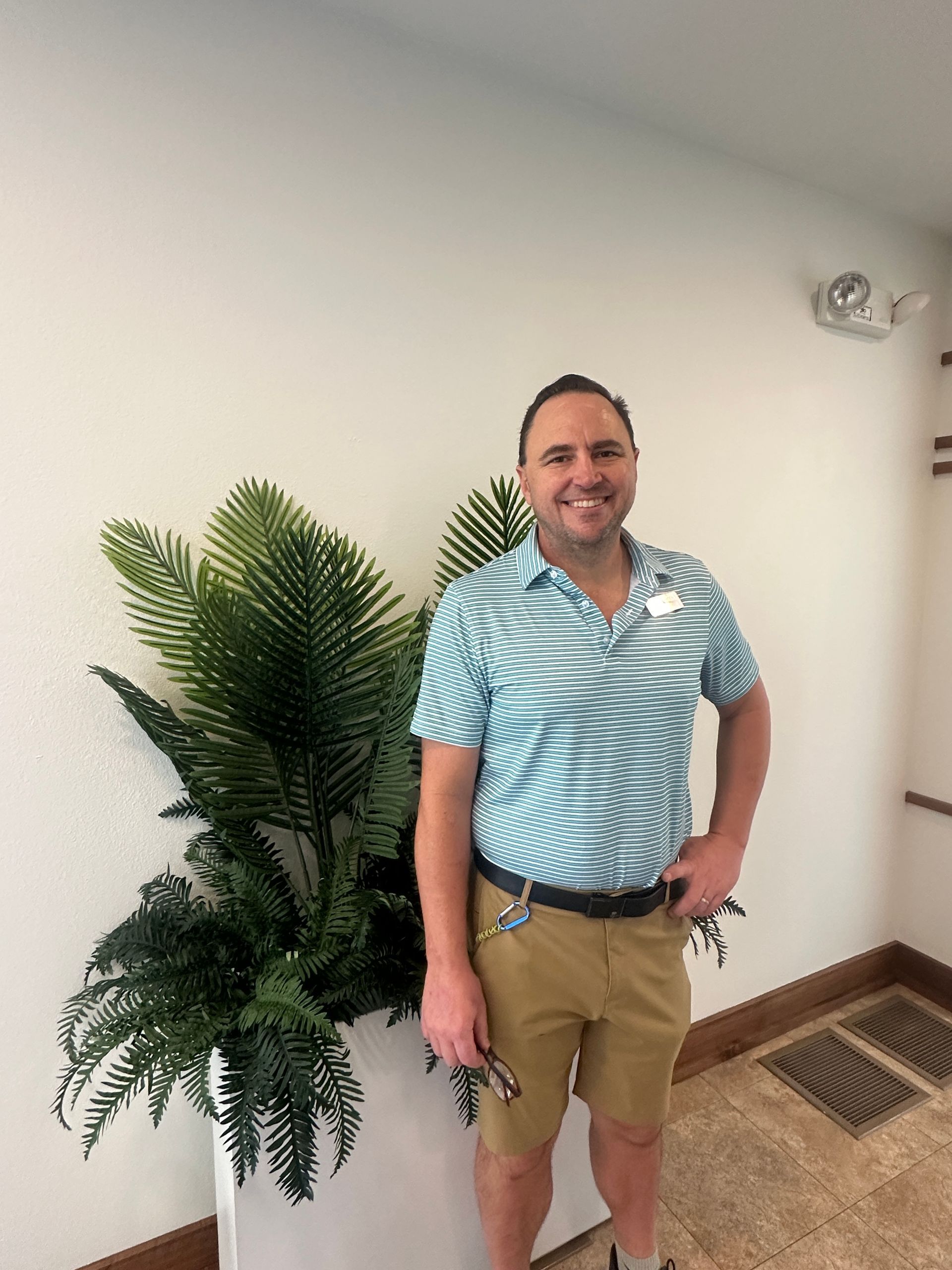 A silhouette of a person without a face on a gray background.