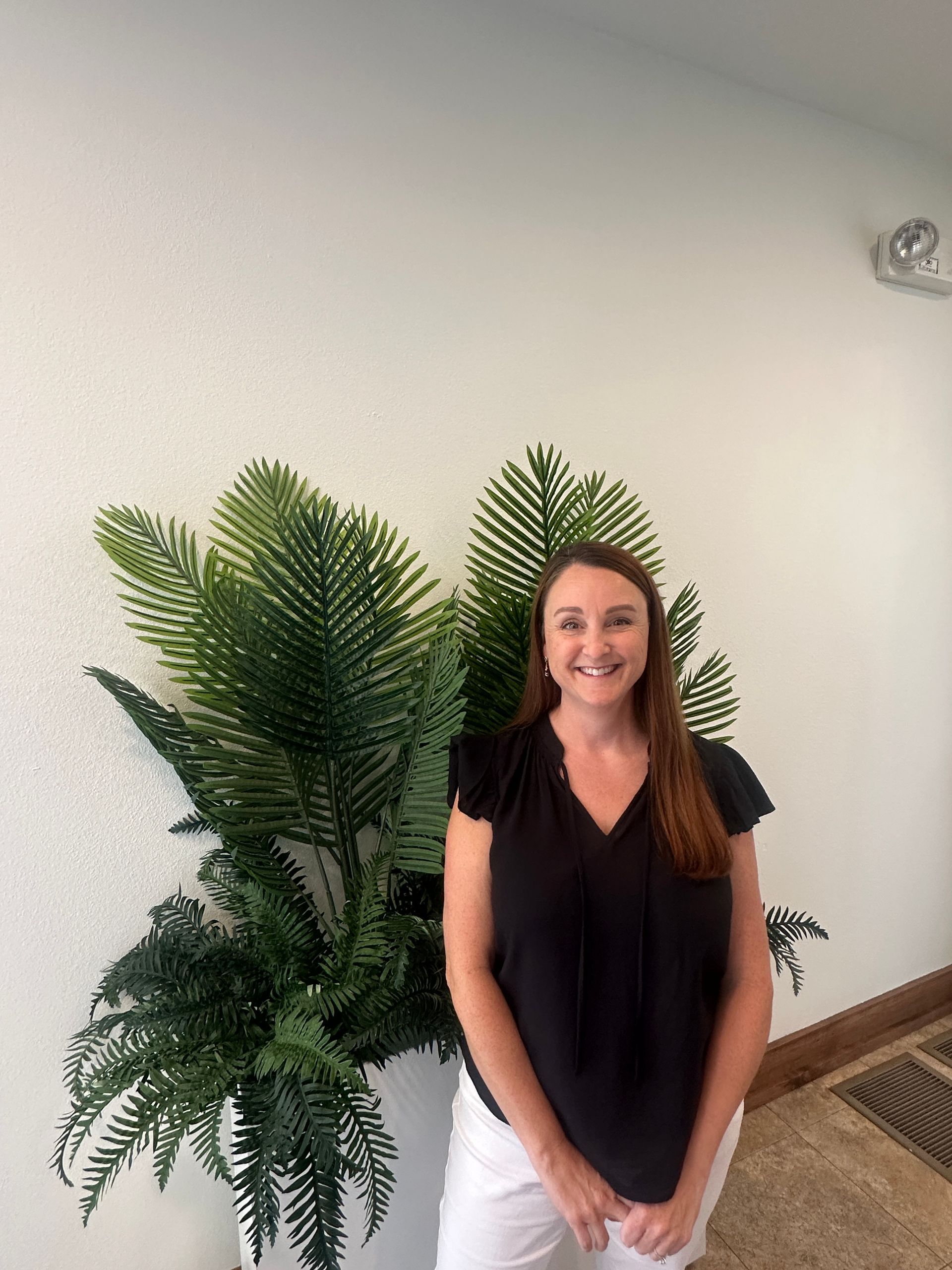 A silhouette of a person without a face on a gray background.