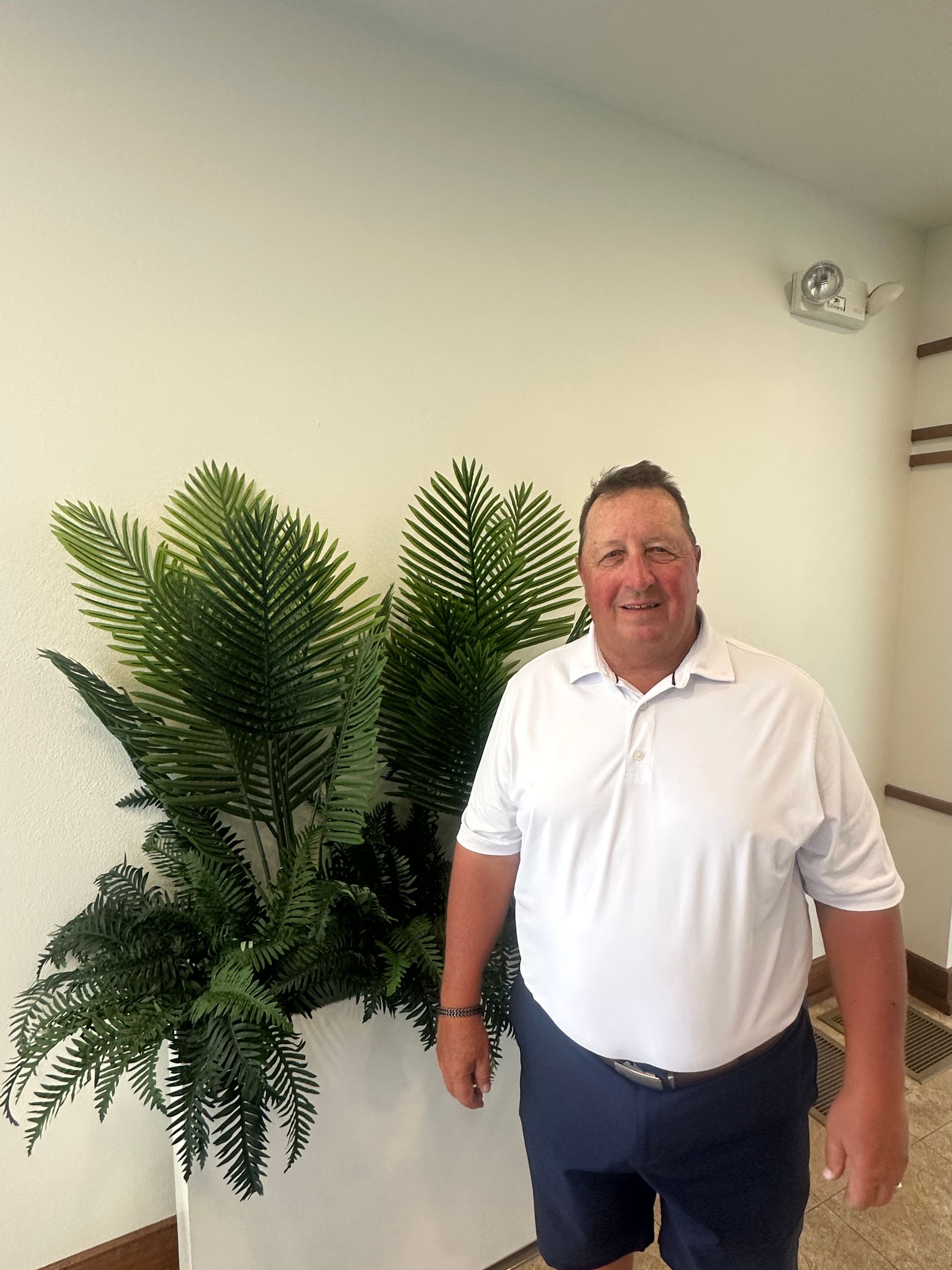 A silhouette of a person without a face on a gray background.