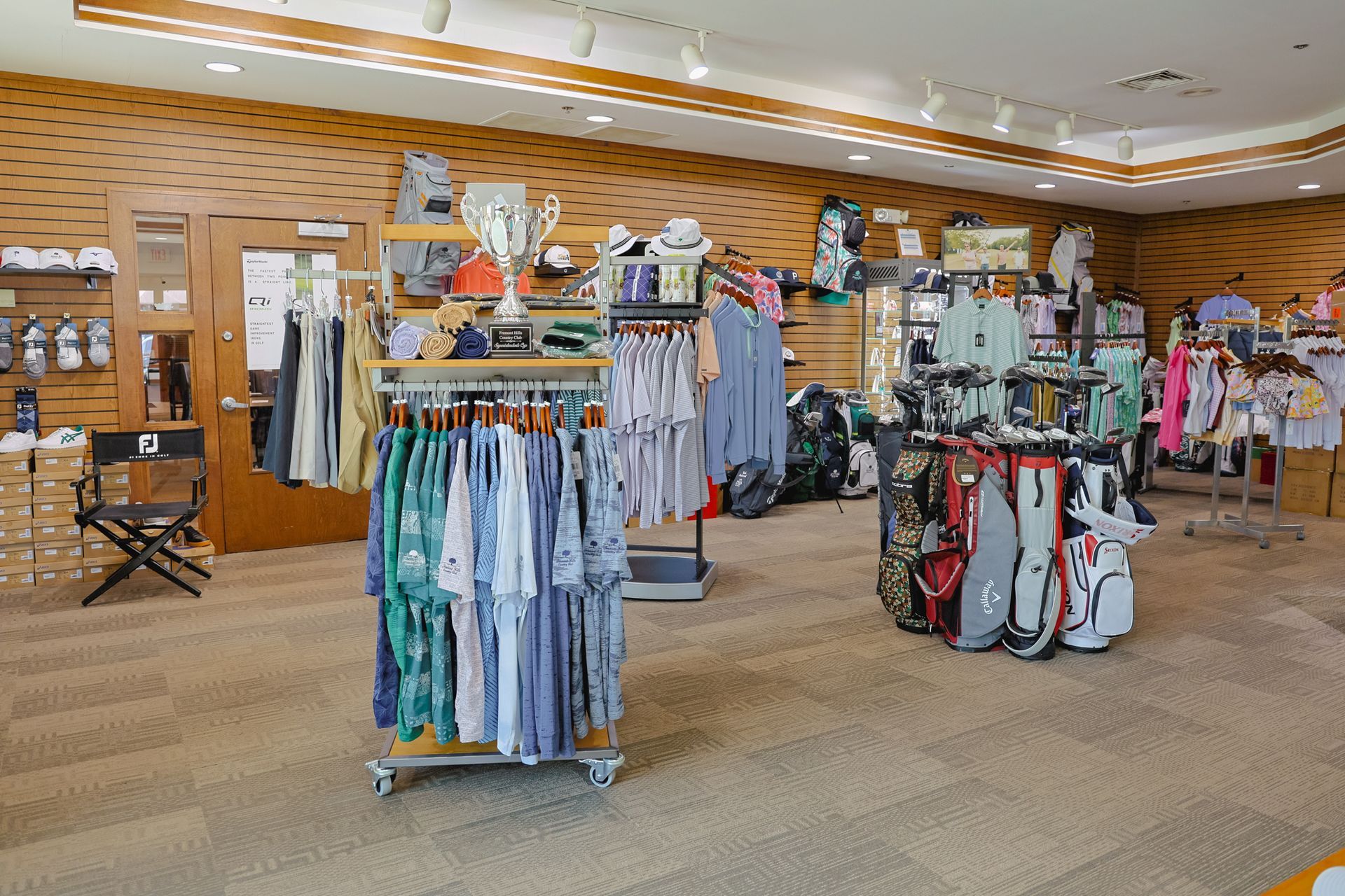 A store filled with lots of clothes and golf bags.