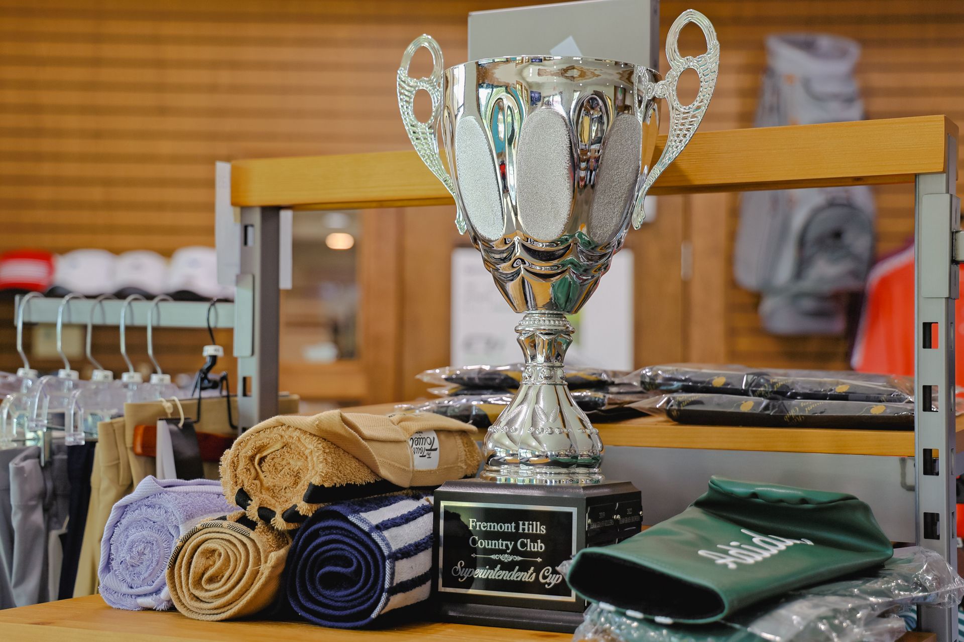 A trophy is sitting on top of a wooden table in a store.