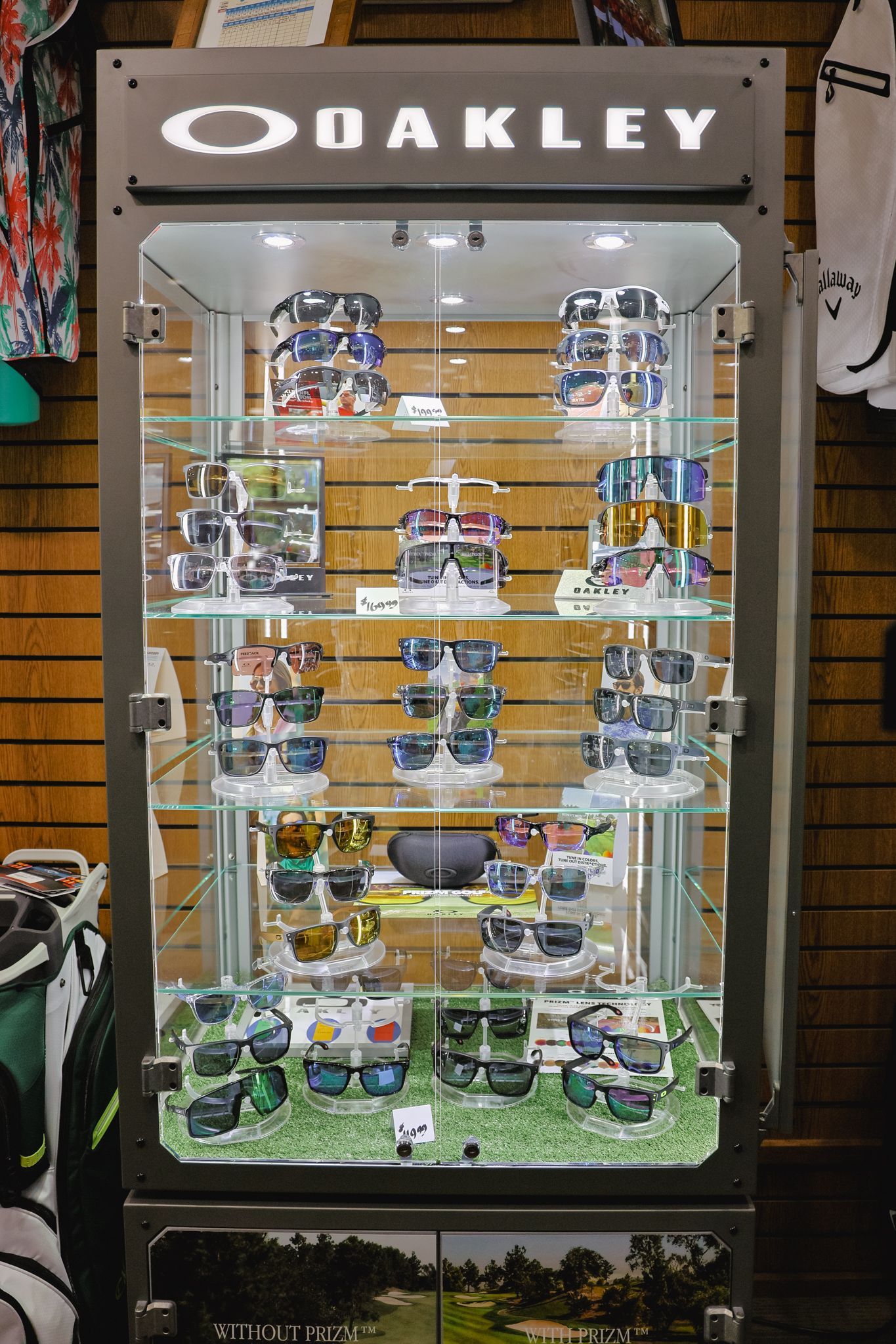 An oakley display case filled with sunglasses in a store.