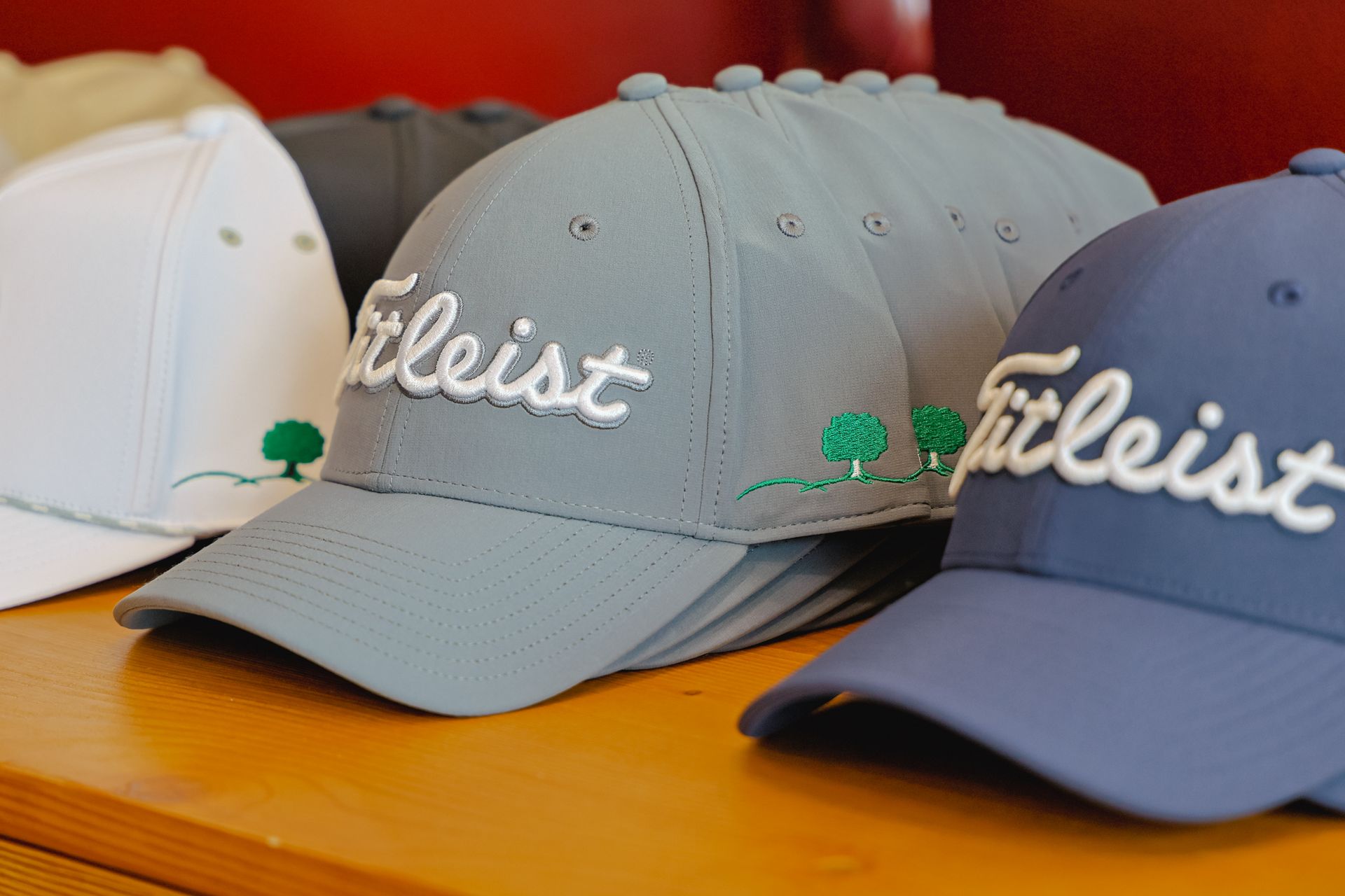 A row of golf hats with titleist embroidered on them