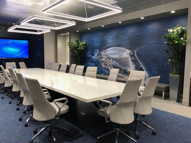 A conference room with a long table and chairs