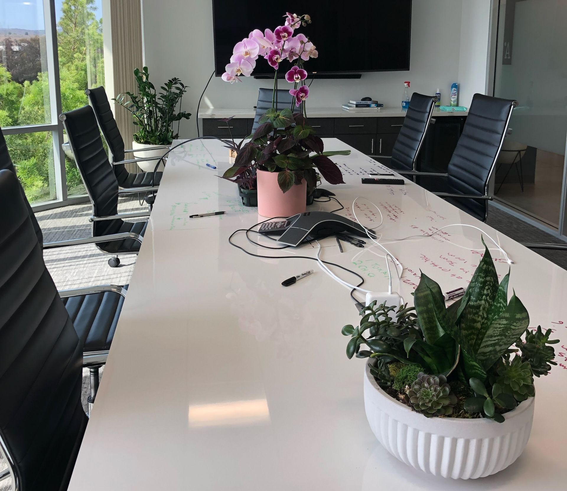 A large vase filled with lots of flowers and plants