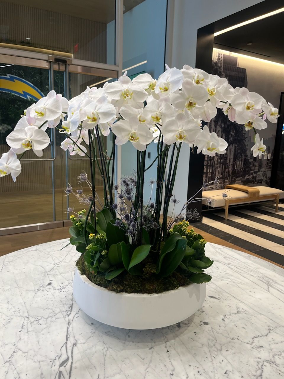 A vase filled with pink and purple flowers is sitting on a table.