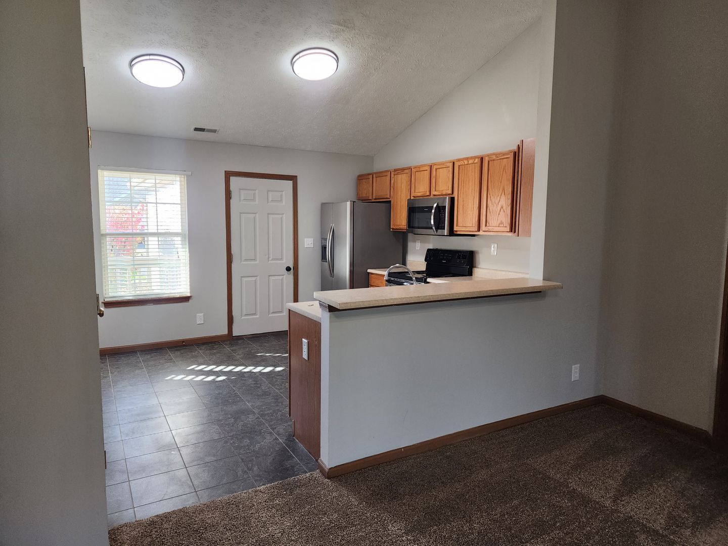 a kitchen with stainless steel appliances and wooden cabinets