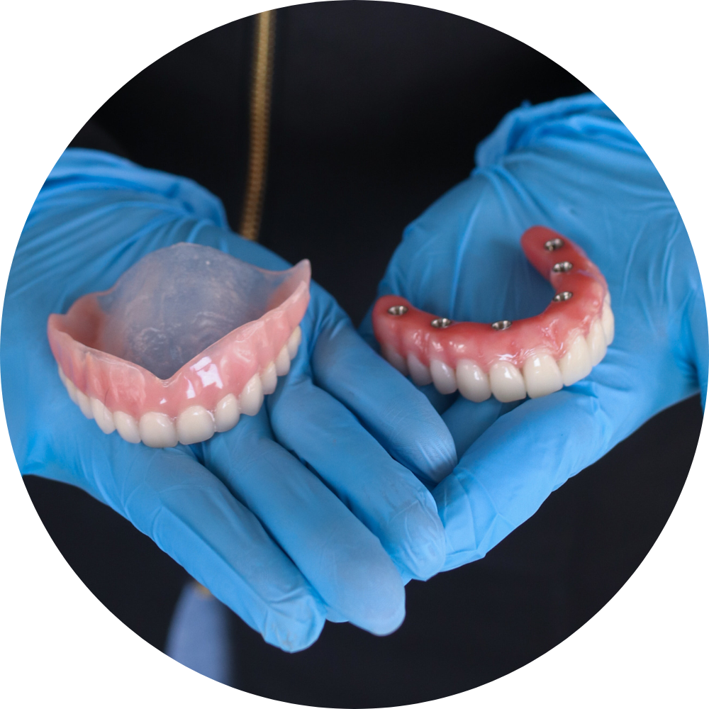 Dentist Holding Teeth | Dentures and Dental Implants | Alexandria VA