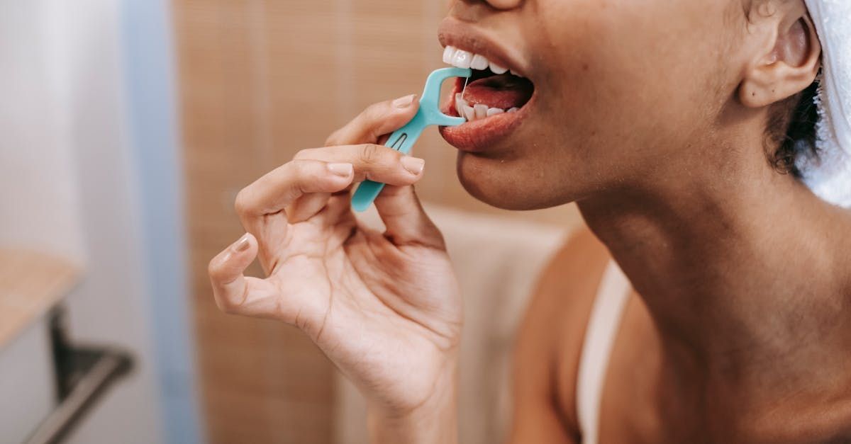 A woman flossing her teeth.