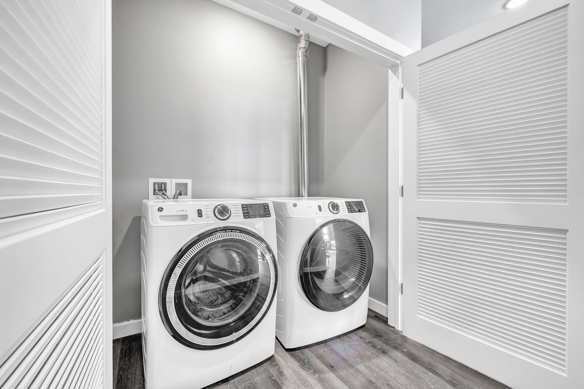 A laundry room with a washer and dryer in it.