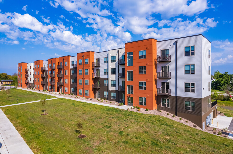 An aerial view of a large apartment building with a lot of windows and balconies.