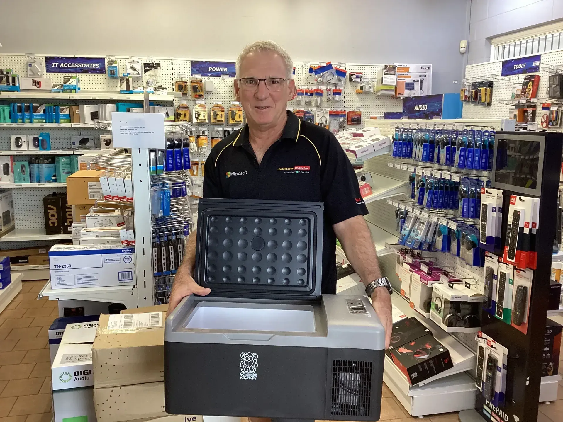 A Man Is Holding A Solar Panel — Dateline Computers Authorised Jaycar Reseller In Cannonvale, QLD