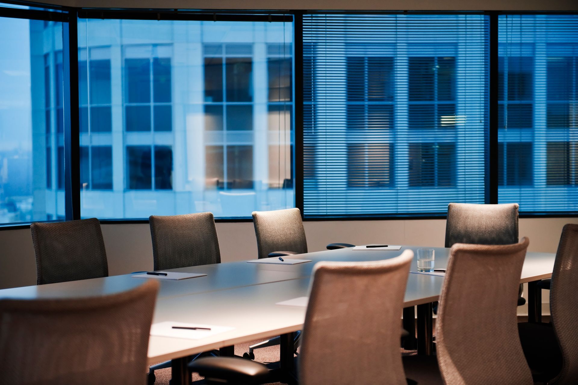 A conference room with a long table and chairs