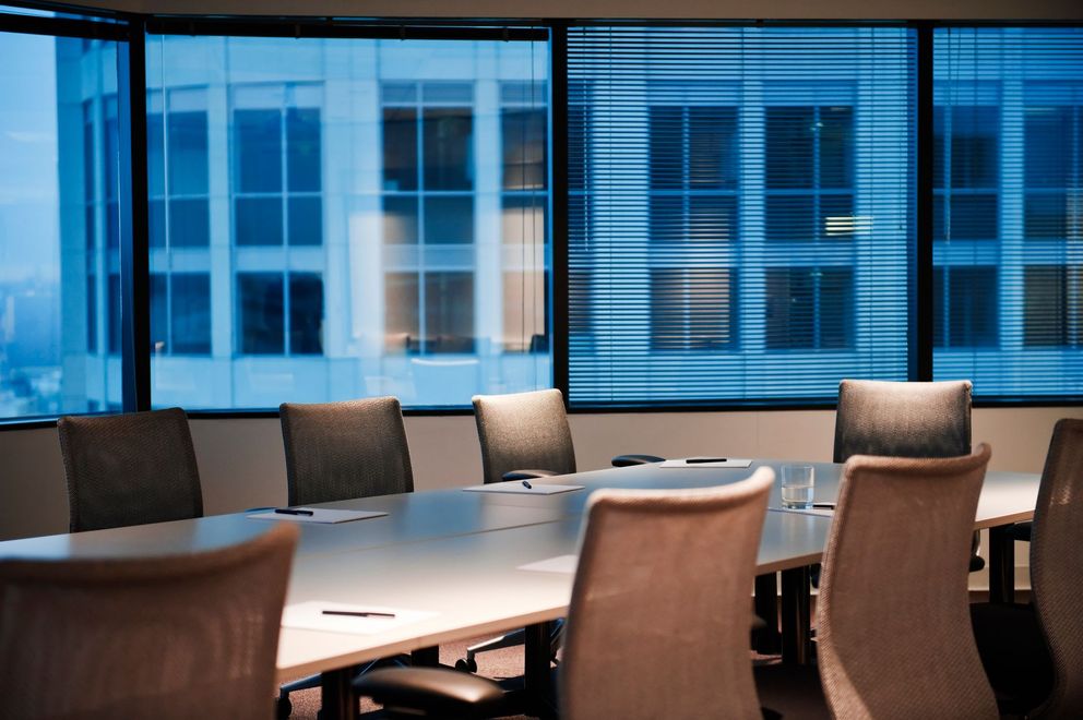 A conference room with a long table and chairs