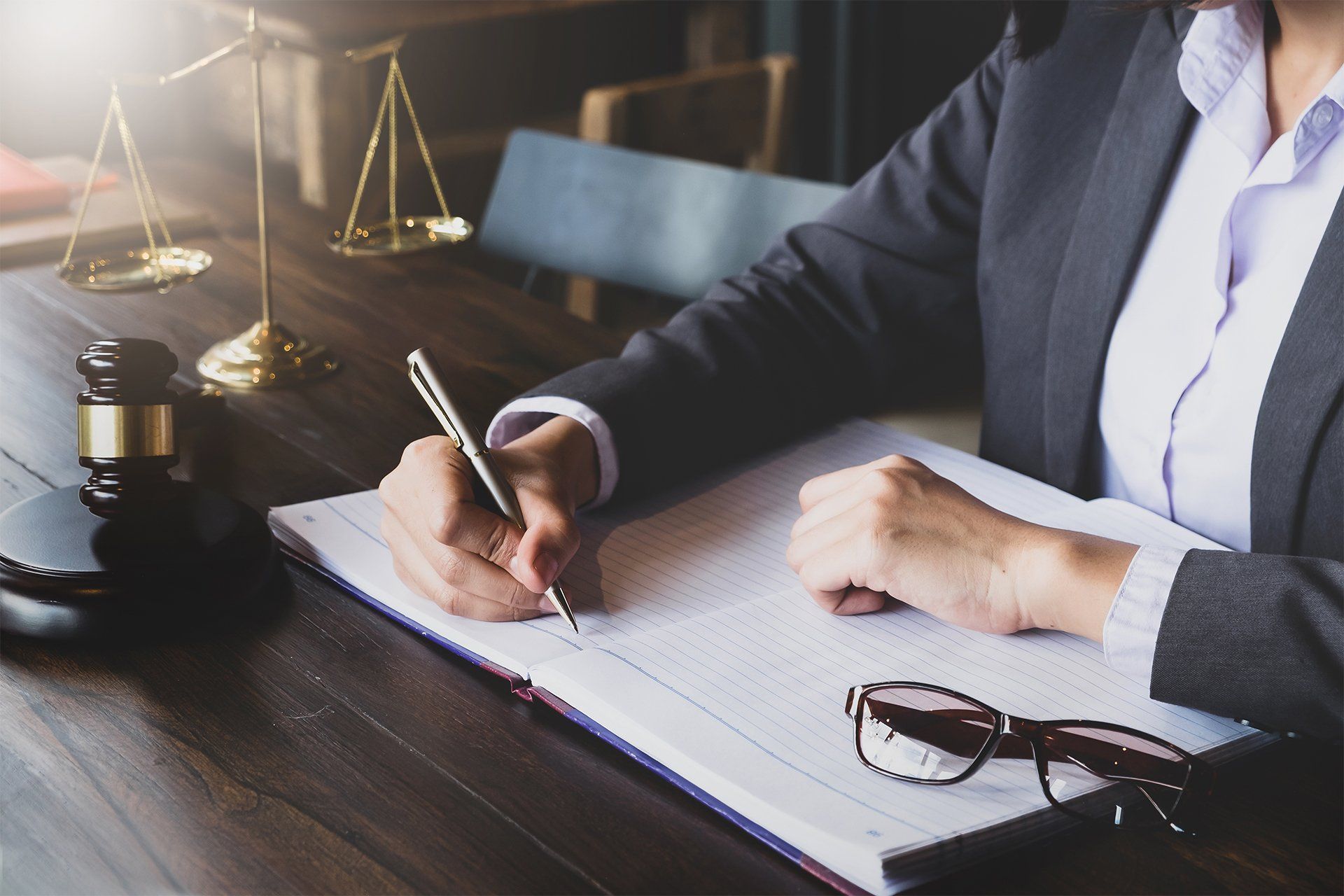 Lawyer Writing on Notebook