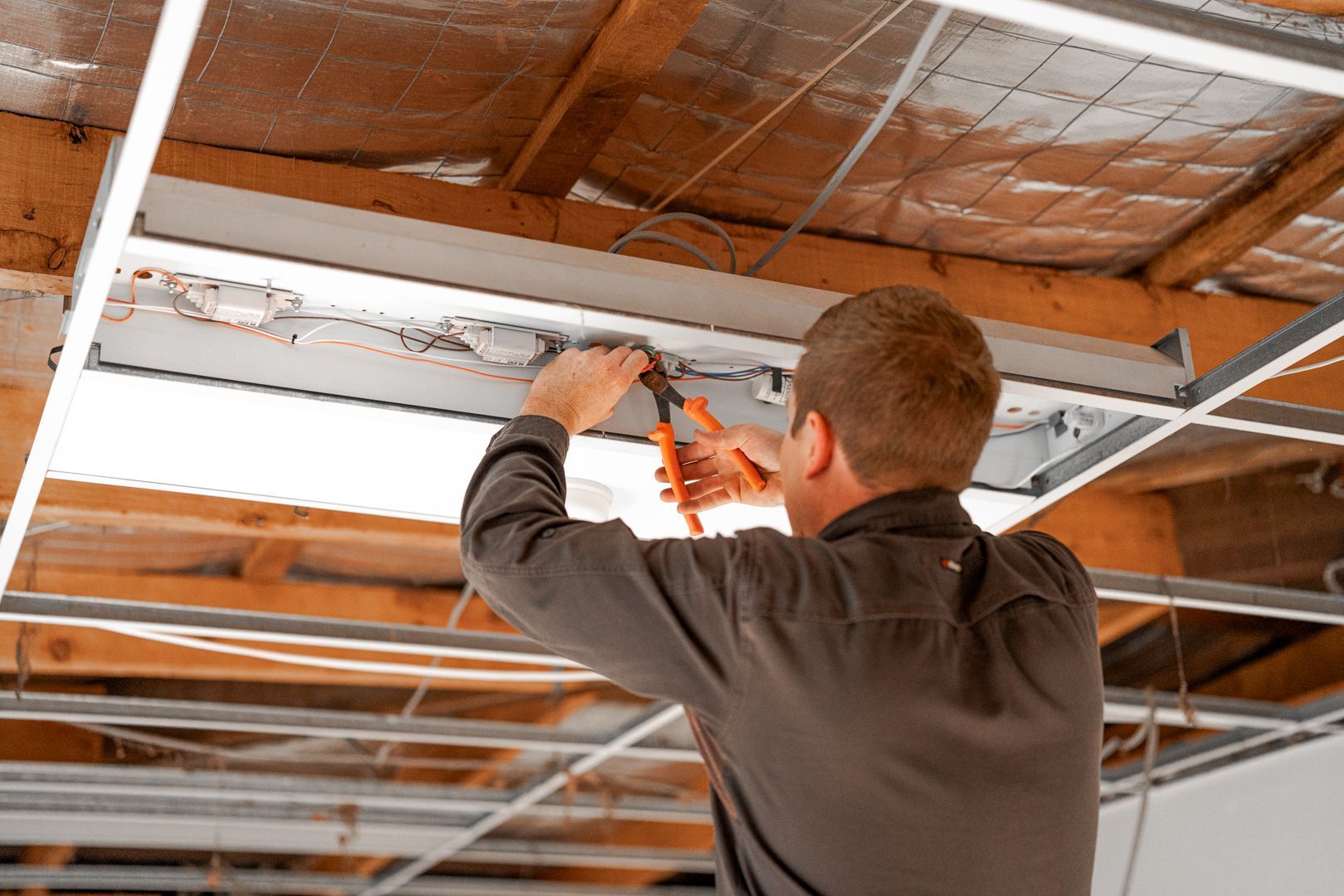 Integrated Servcies team member installing electrical 
