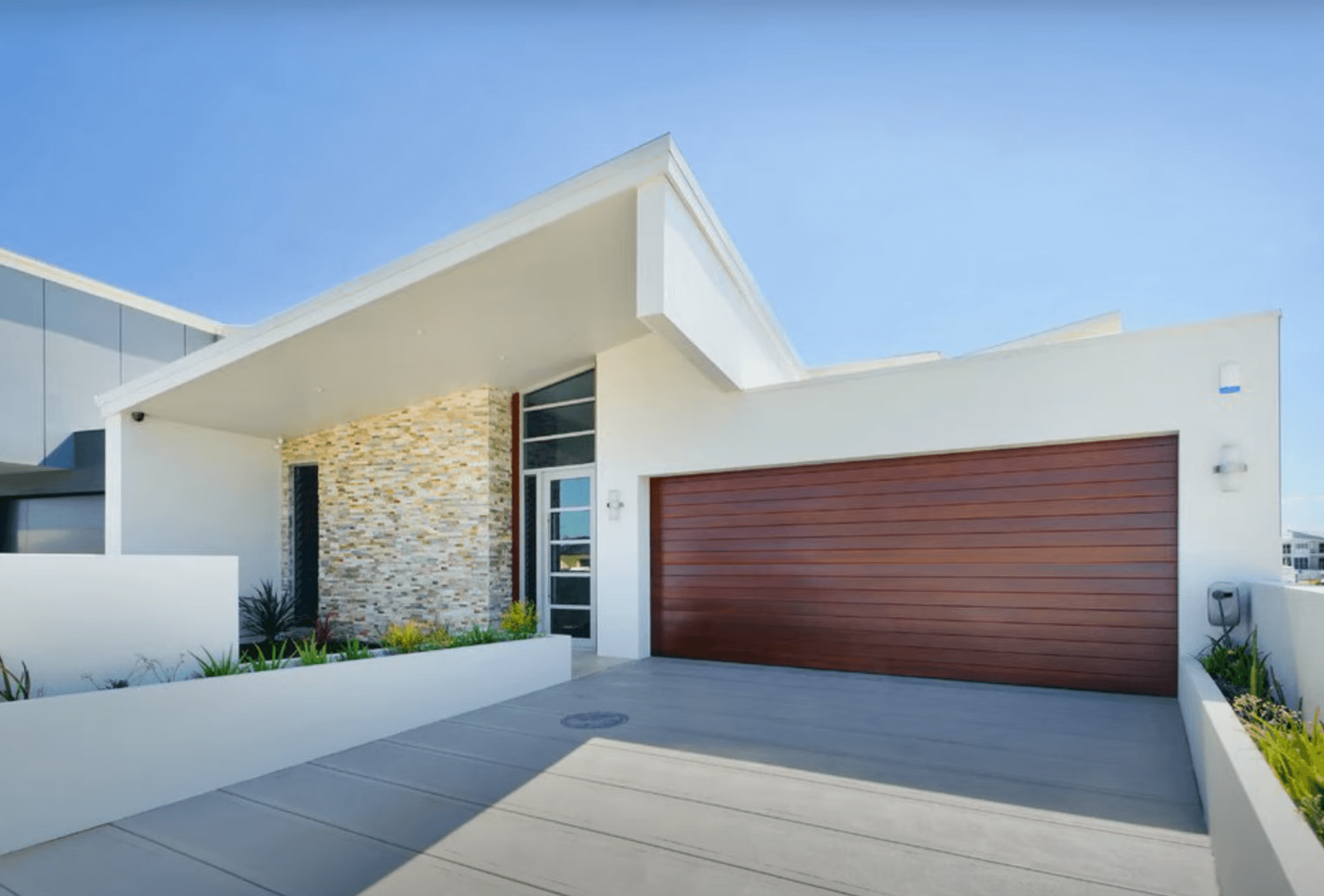 Modern house with a concrete driveway with expansion lines giving it a modern and unique look
