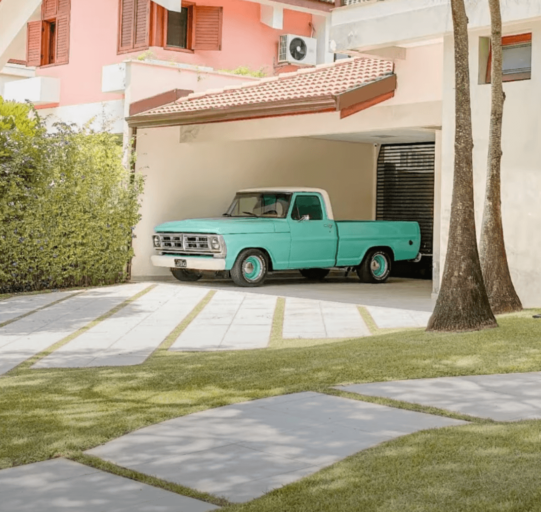 old green truck on a poured concrete driveway