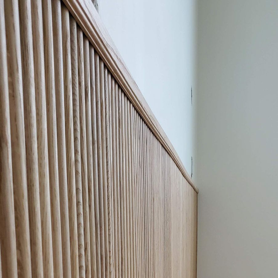 A close up of a wooden feature wall in a room.